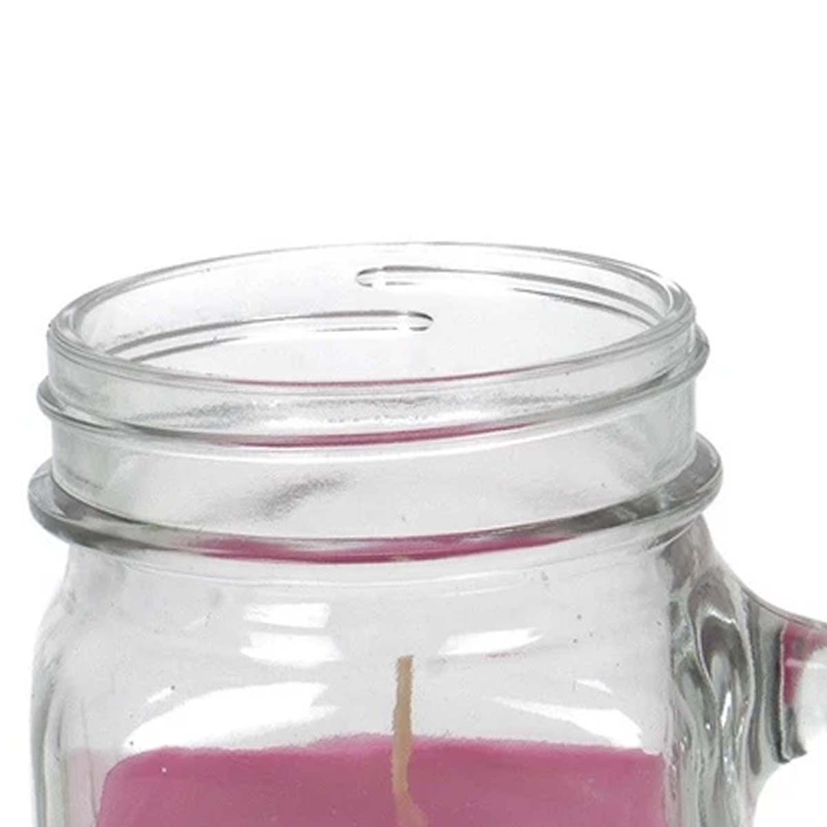 Primo piano della parte superiore di un barattolo Mason con candela rosa e stoppino.