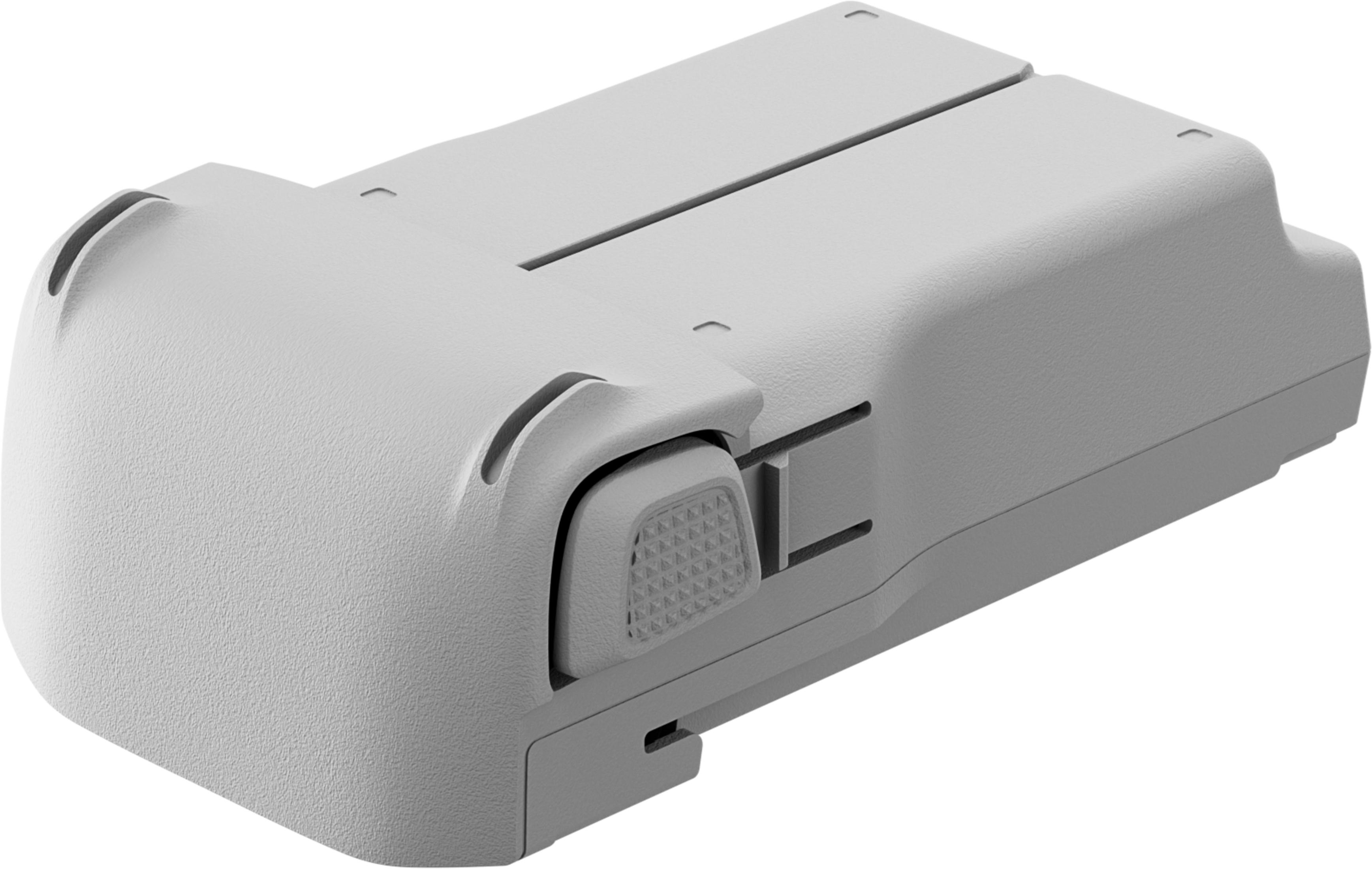Batteria grigia con pulsante di rilascio e fessure, su sfondo bianco.