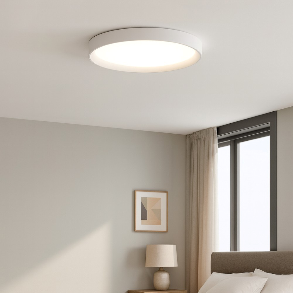Una plafoniera bianca illumina una camera da letto con letto e quadro.