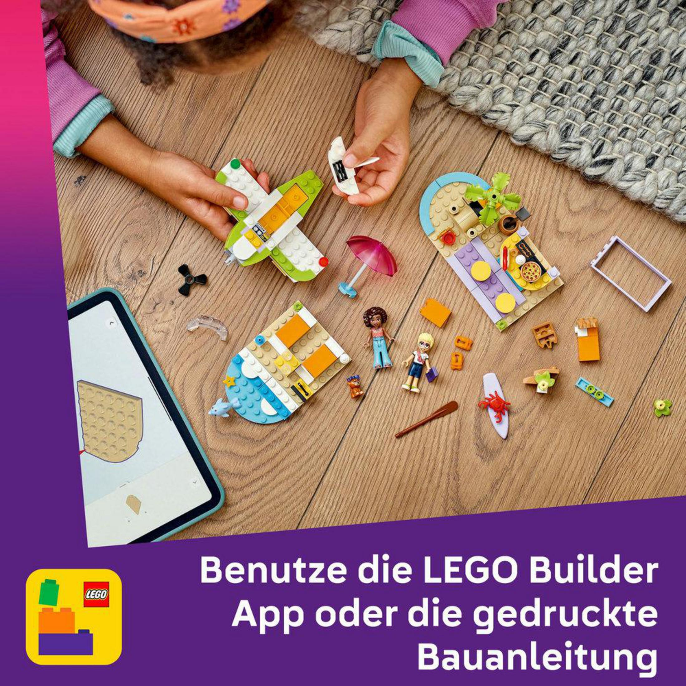 Dziecko bawi się klockami LEGO na drewnianej podłodze z tabletem i instrukcją.