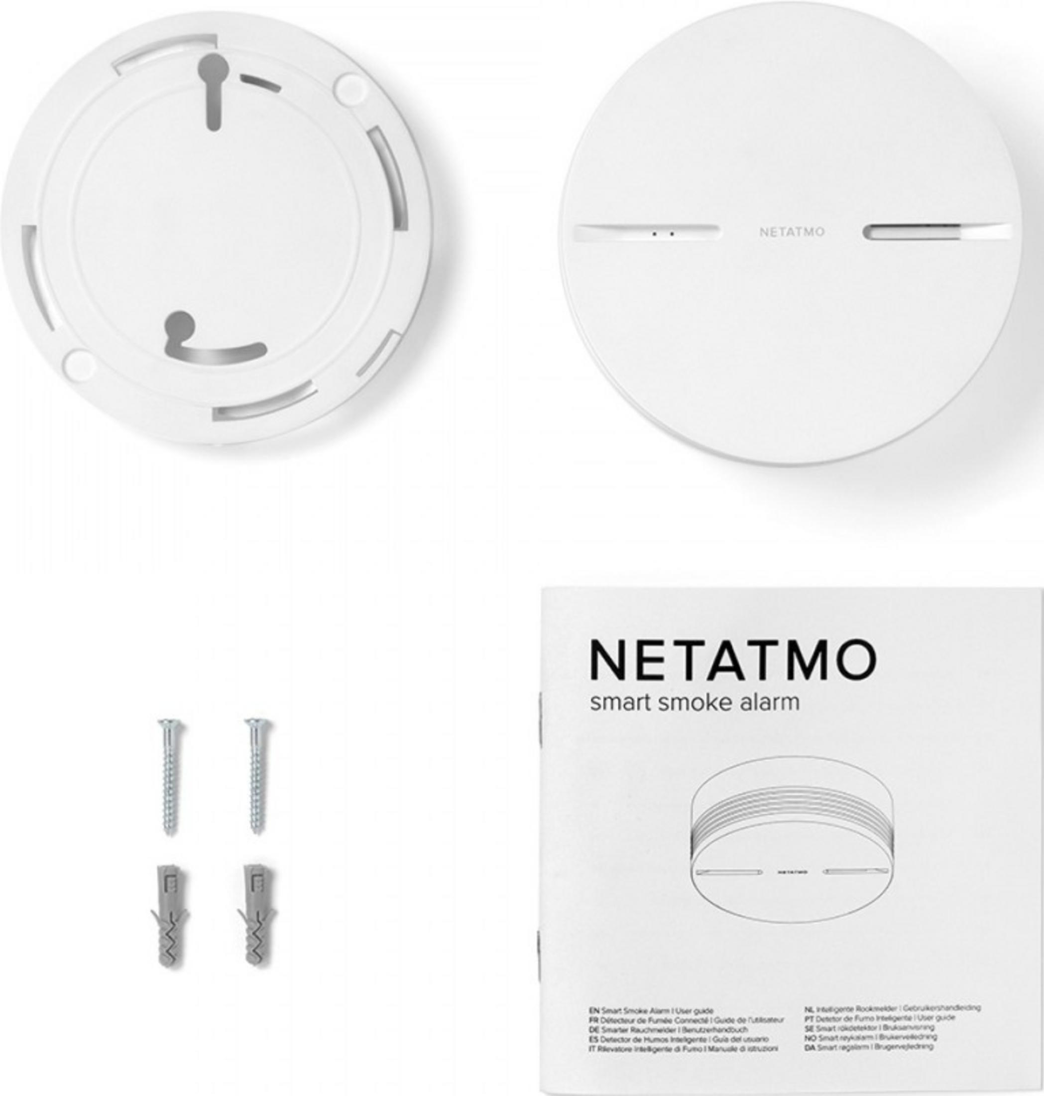 White Netatmo smoke alarm components and manual on a white background.