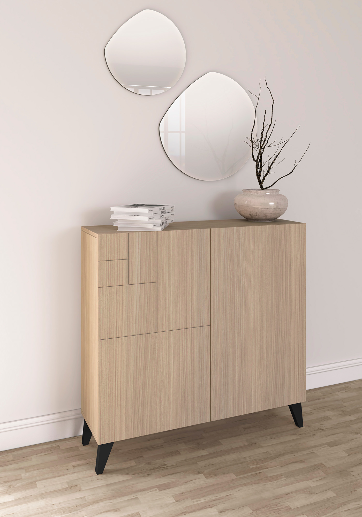 Un mueble de madera clara con patas negras, encima libros y un jarrón con ramas.