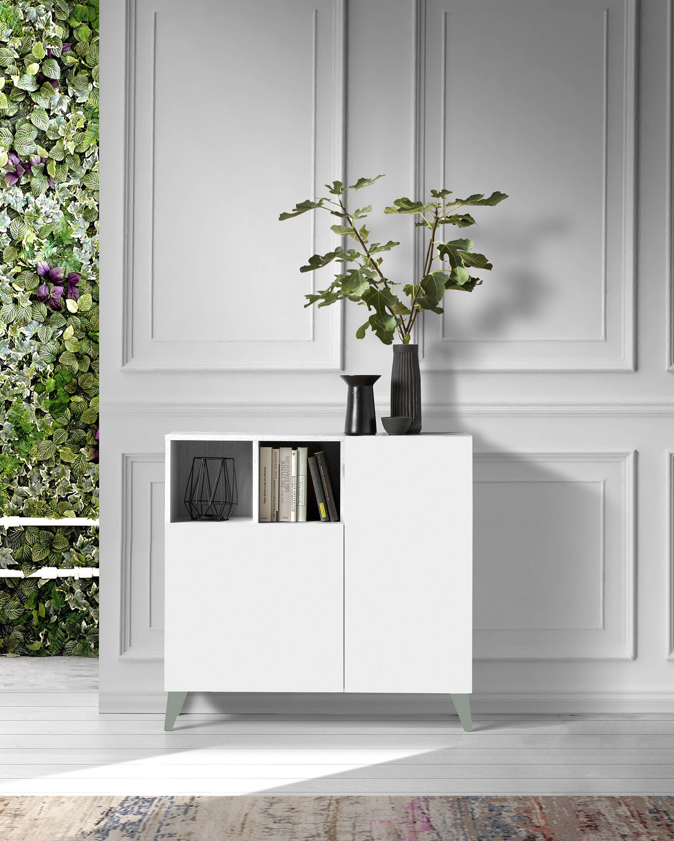 Armario blanco con plantas y libros, junto a una pared verde.