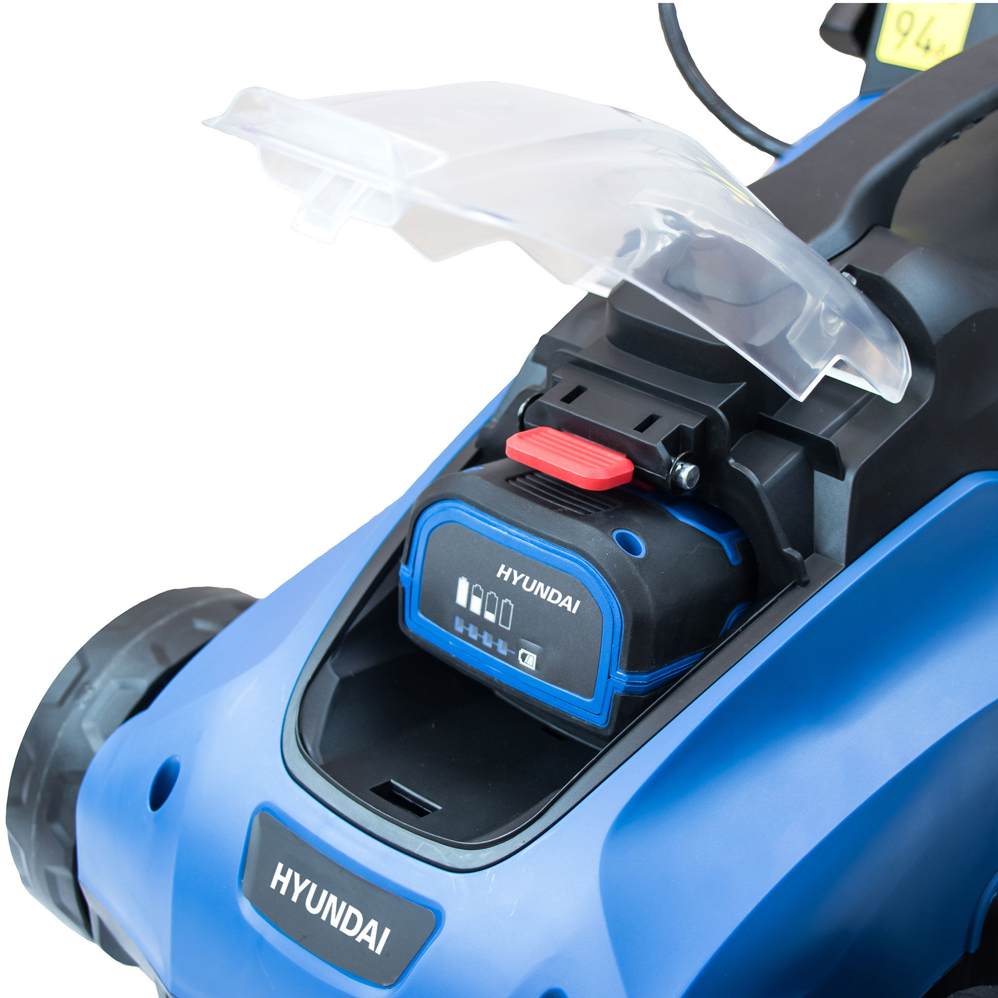 Cortacésped azul con batería extraíble y tapa transparente abierta.