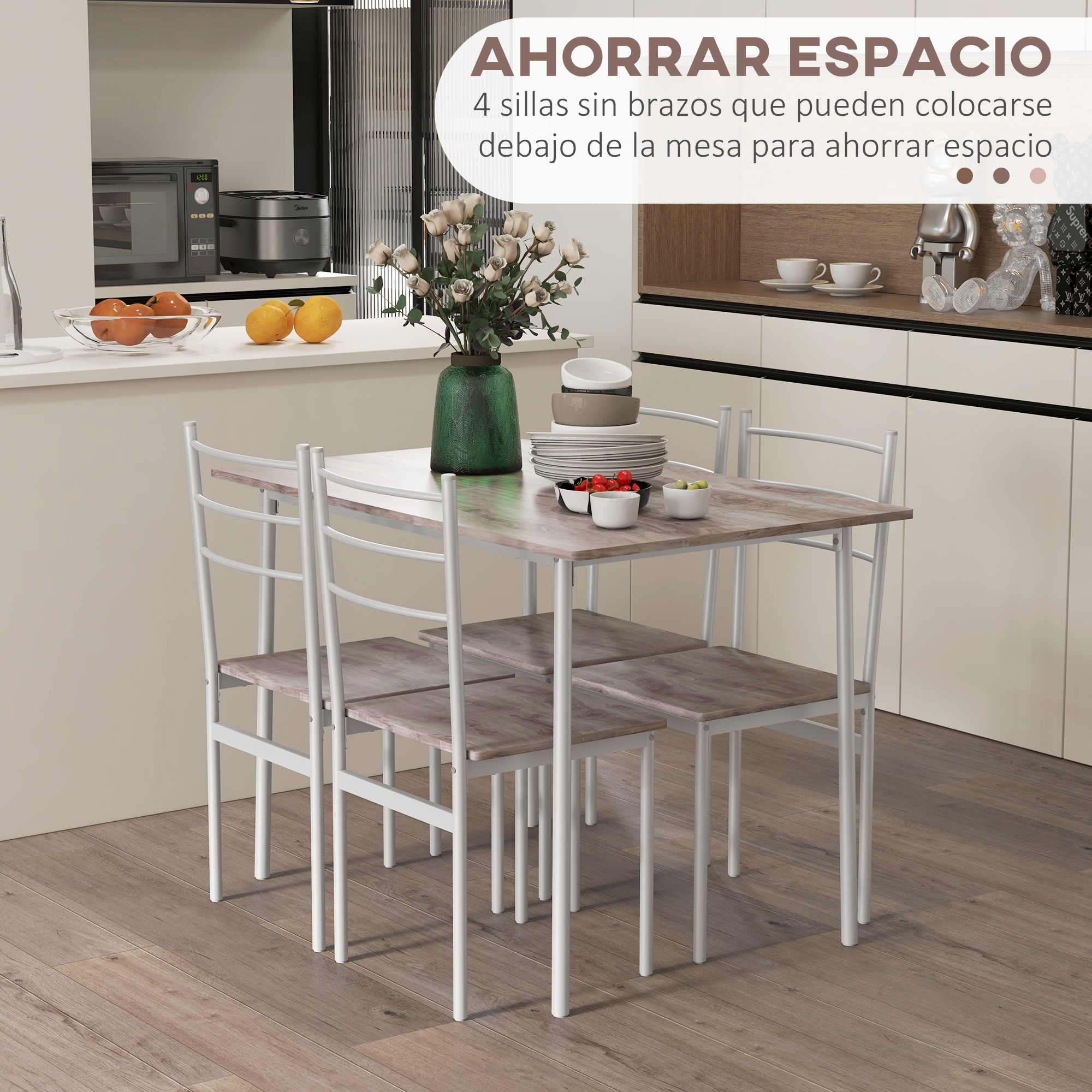 Una mesa de cocina con cuatro sillas blancas que caben debajo. Decorada con frutas y platos.
