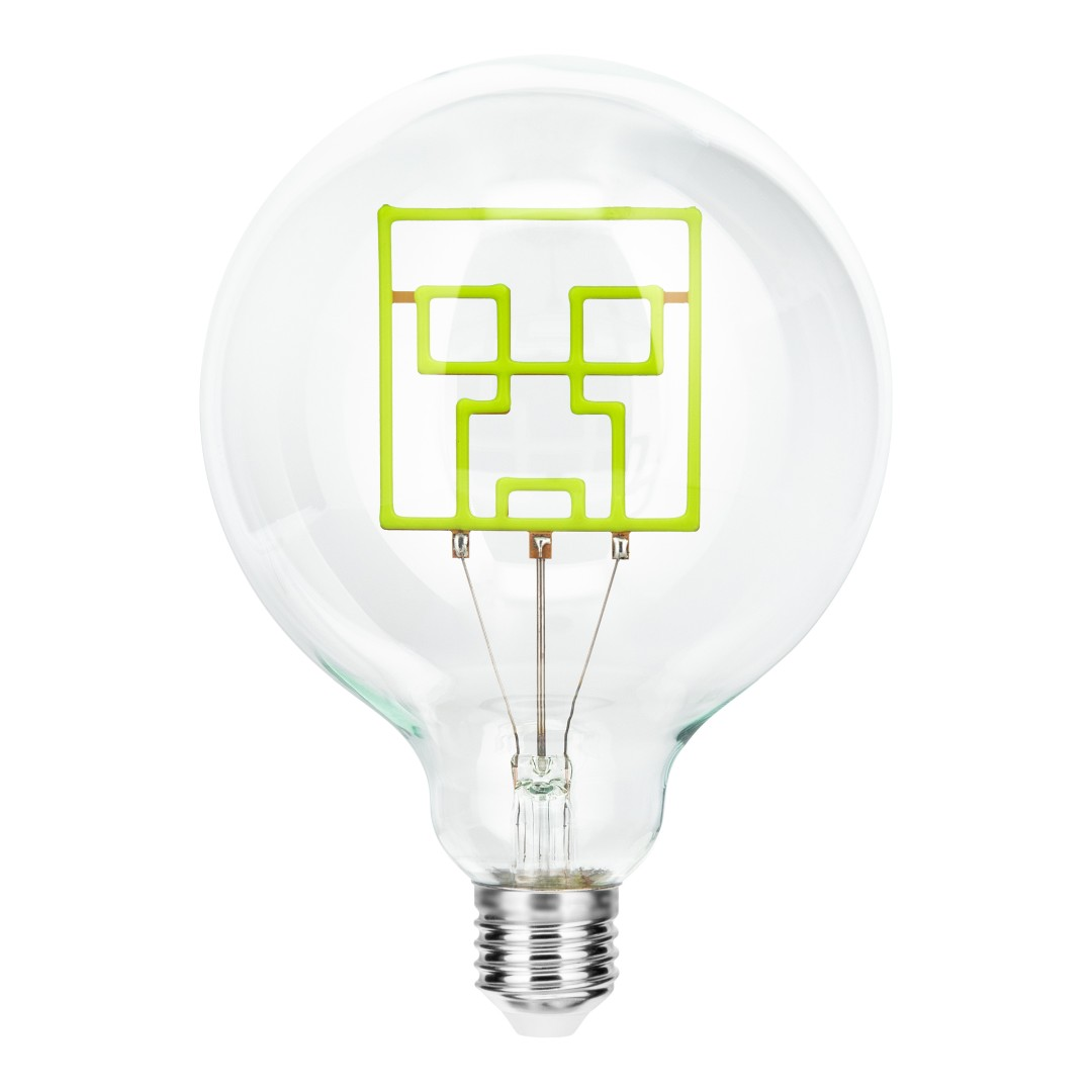 Una lampadina trasparente con un design a faccia Creeper Minecraft verde.