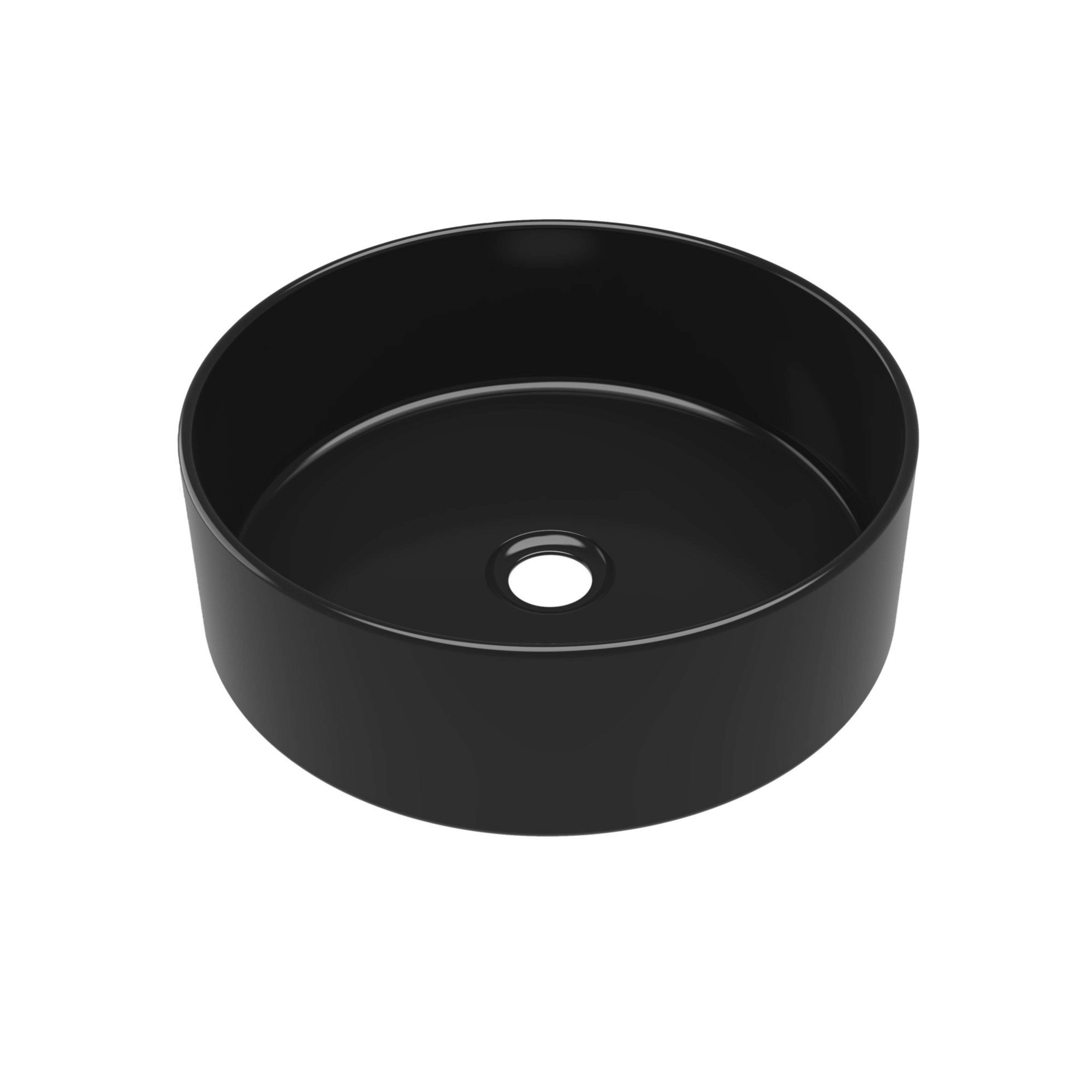 Lavabo de encimera redondo y negro con un agujero de drenaje en el centro.