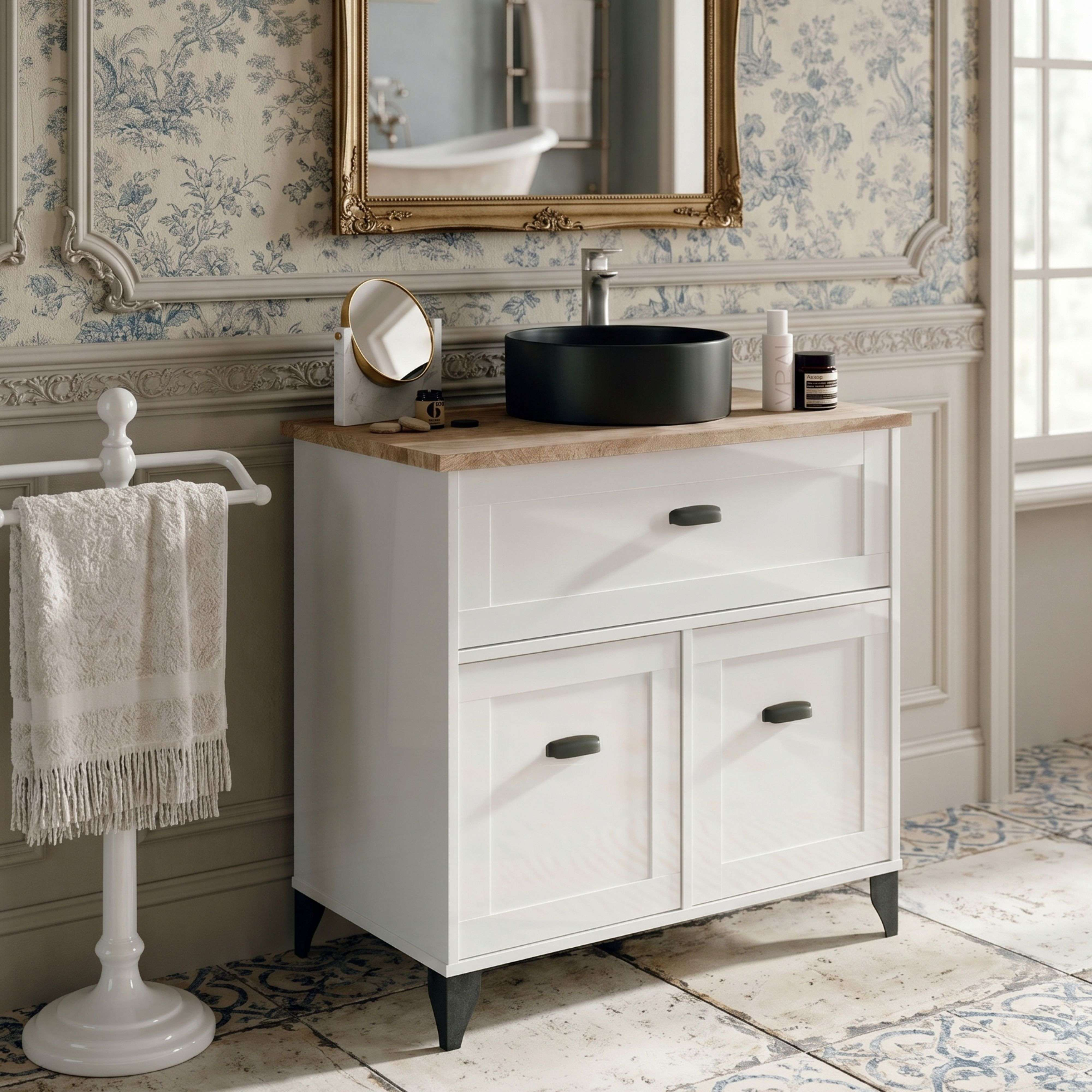 Un tocador blanco con lavabo negro y encimera de madera, junto a un toallero.