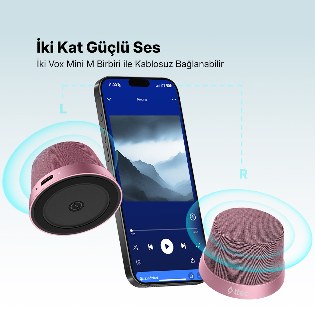 Müzik çalan bir akıllı telefonun iki yanında pembe renkli hoparlörler.