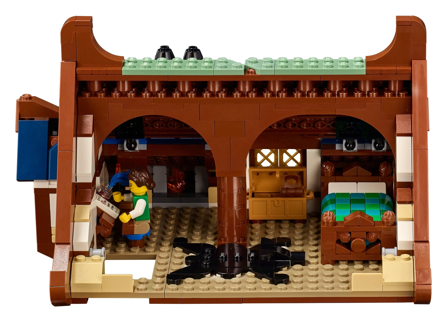 Eine Lego-Figur in einem braunen Haus mit Bett und Truhe.