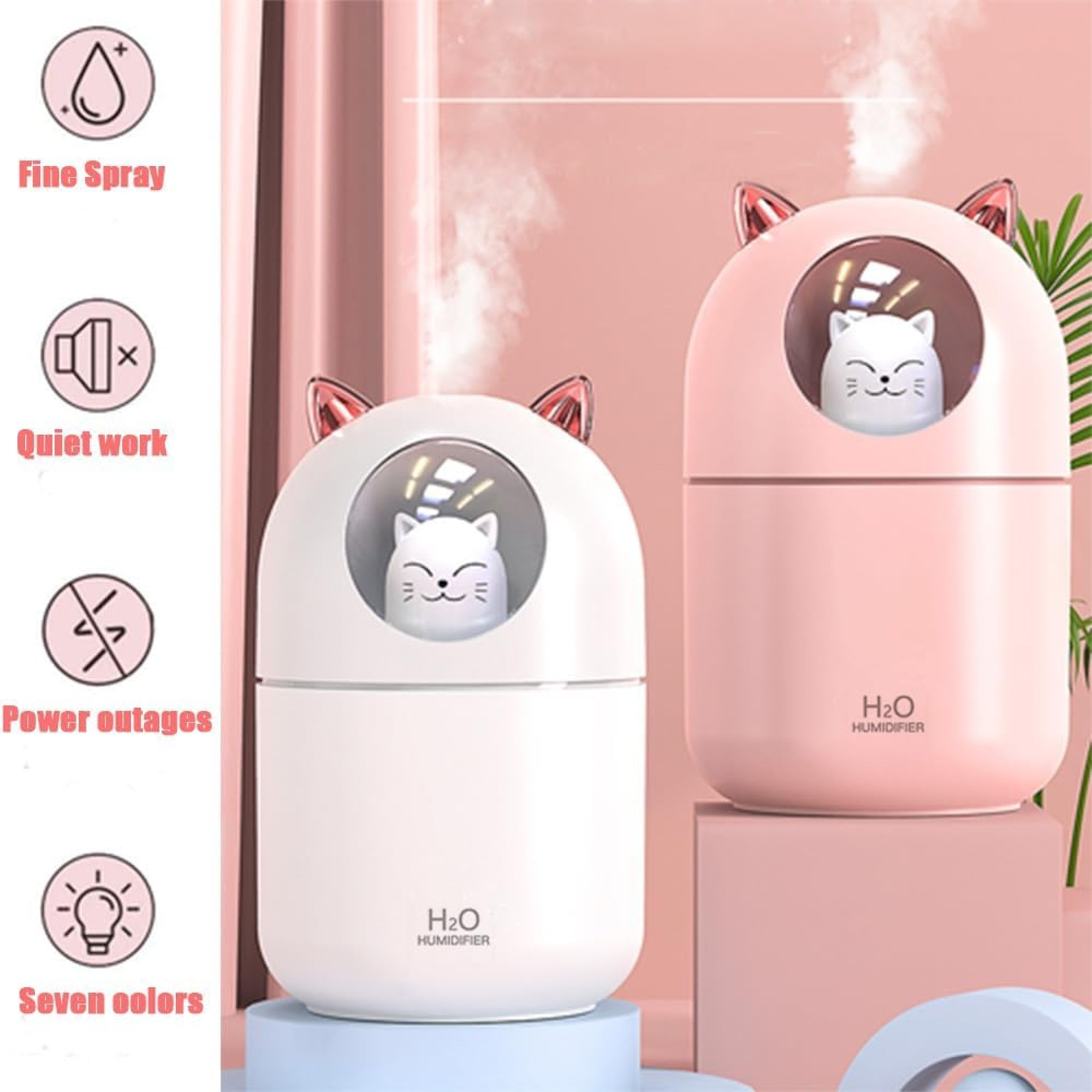 Zwei katzenförmige Luftbefeuchter, einer weiß, einer pink, stoßen Nebel aus.