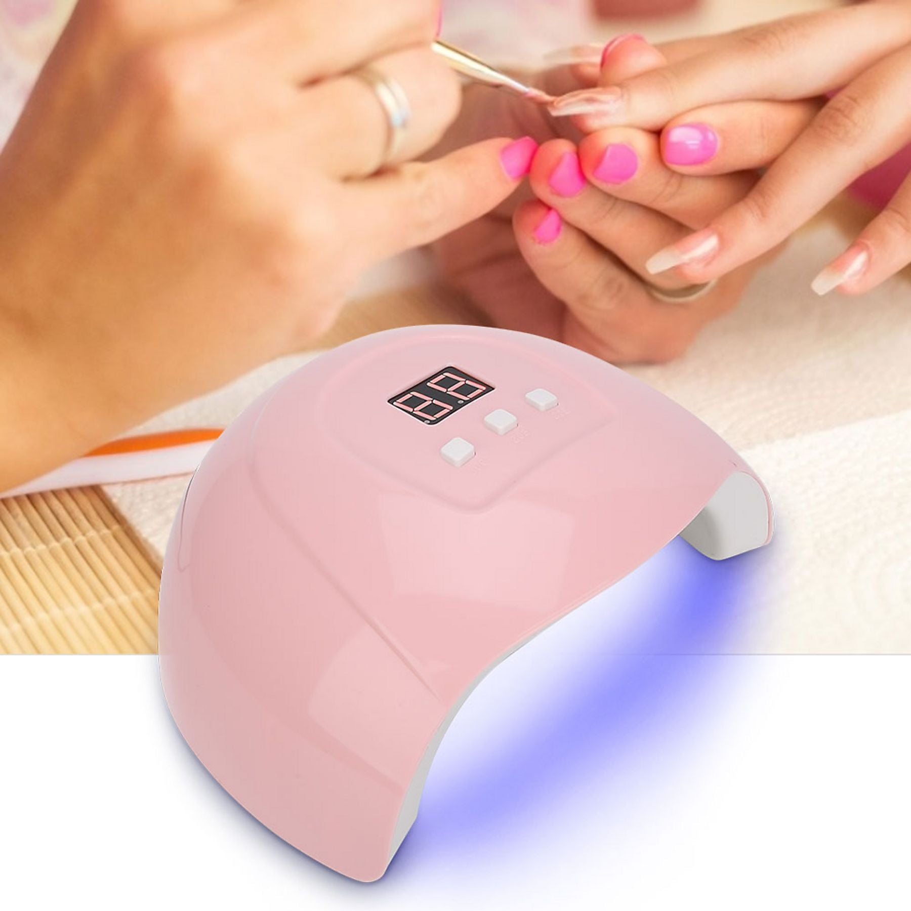 Eine rosafarbene UV-Nagellampe mit einem digitalen Display und drei Knöpfen.