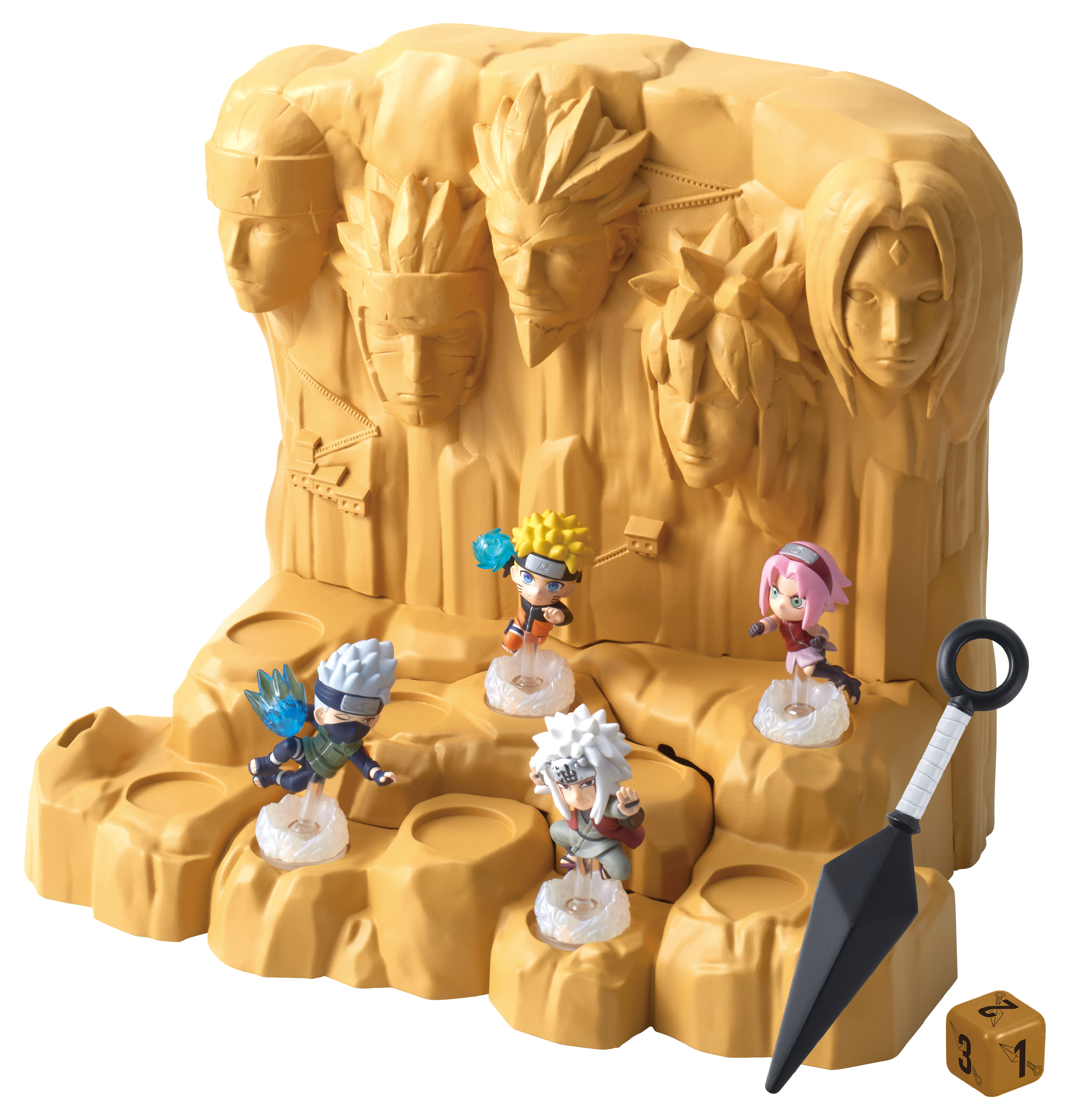 Figuras de Naruto en base rocosa con rostros, un shuriken y un dado.