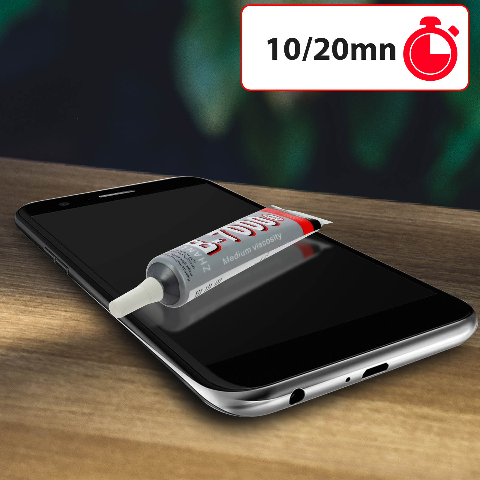 Un tubetto di colla B-7000 a media viscosità poggia sullo schermo di uno smartphone nero.