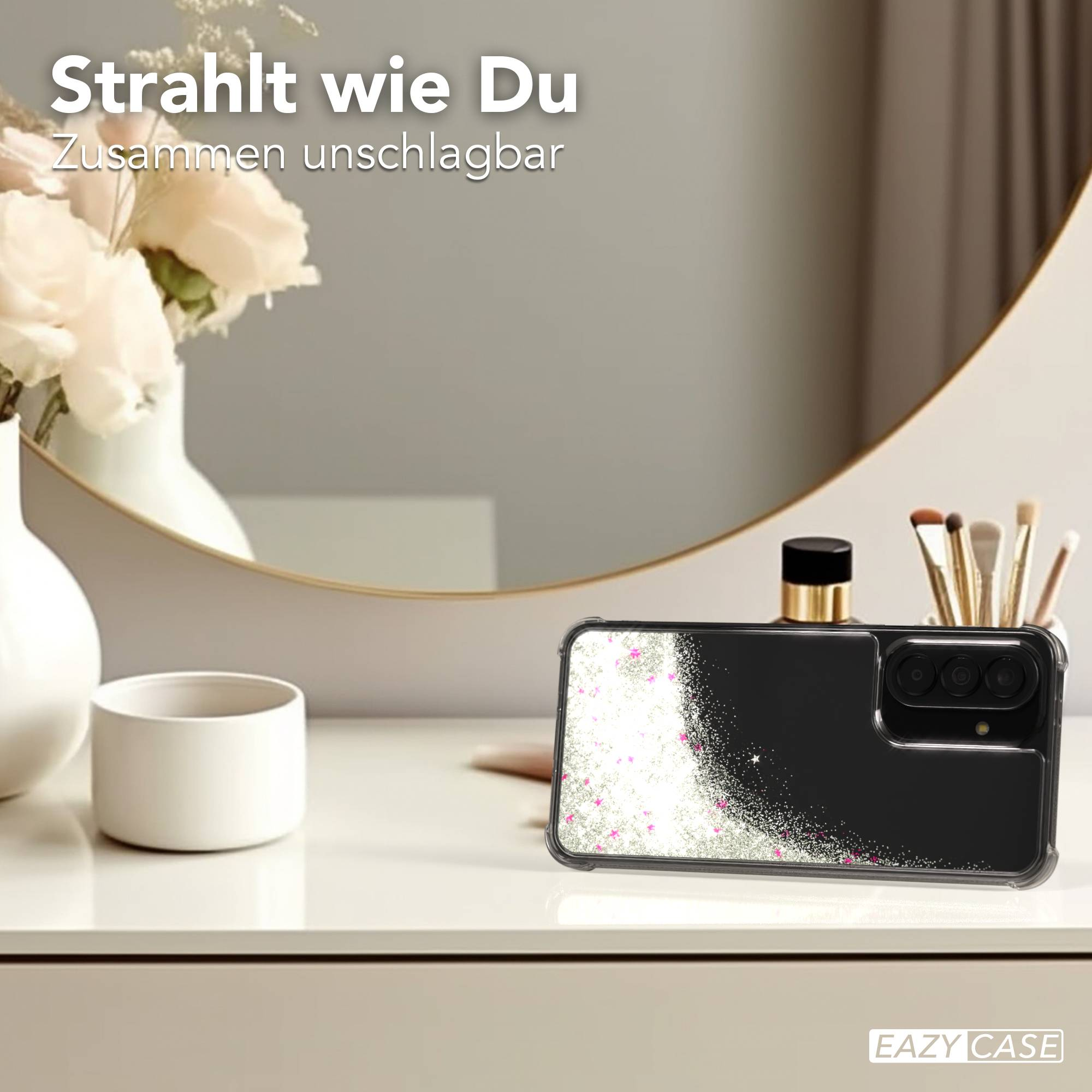 Schwarze Handyhülle mit Glitzer und rosa Sternen auf einem Tisch.