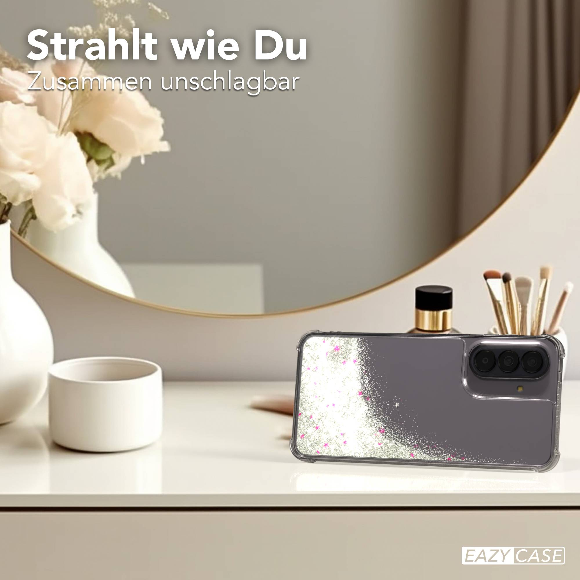 Graue Handyhülle mit Glitzer und rosa Sternen auf einem Tisch.