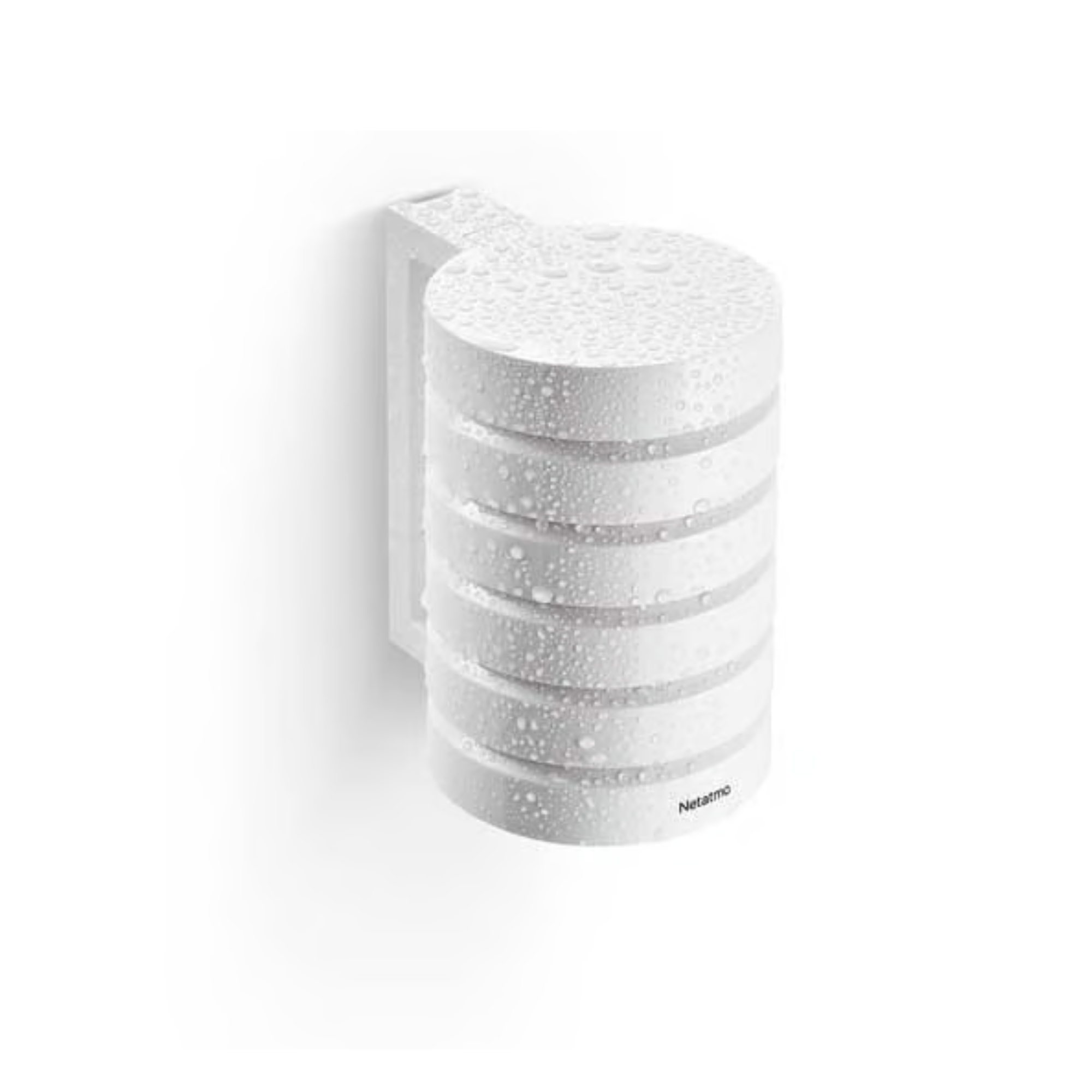 White, cylindrical Netatmo outdoor unit with water droplets, mounted on a wall.
