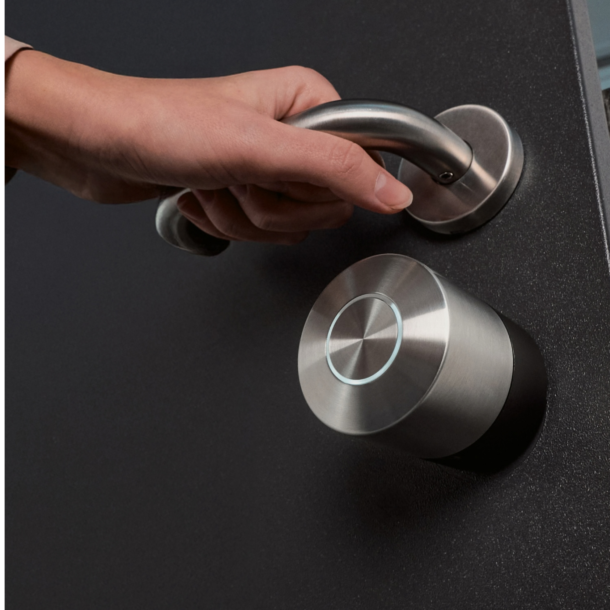 A hand operates a silver door handle next to a silver smart lock.