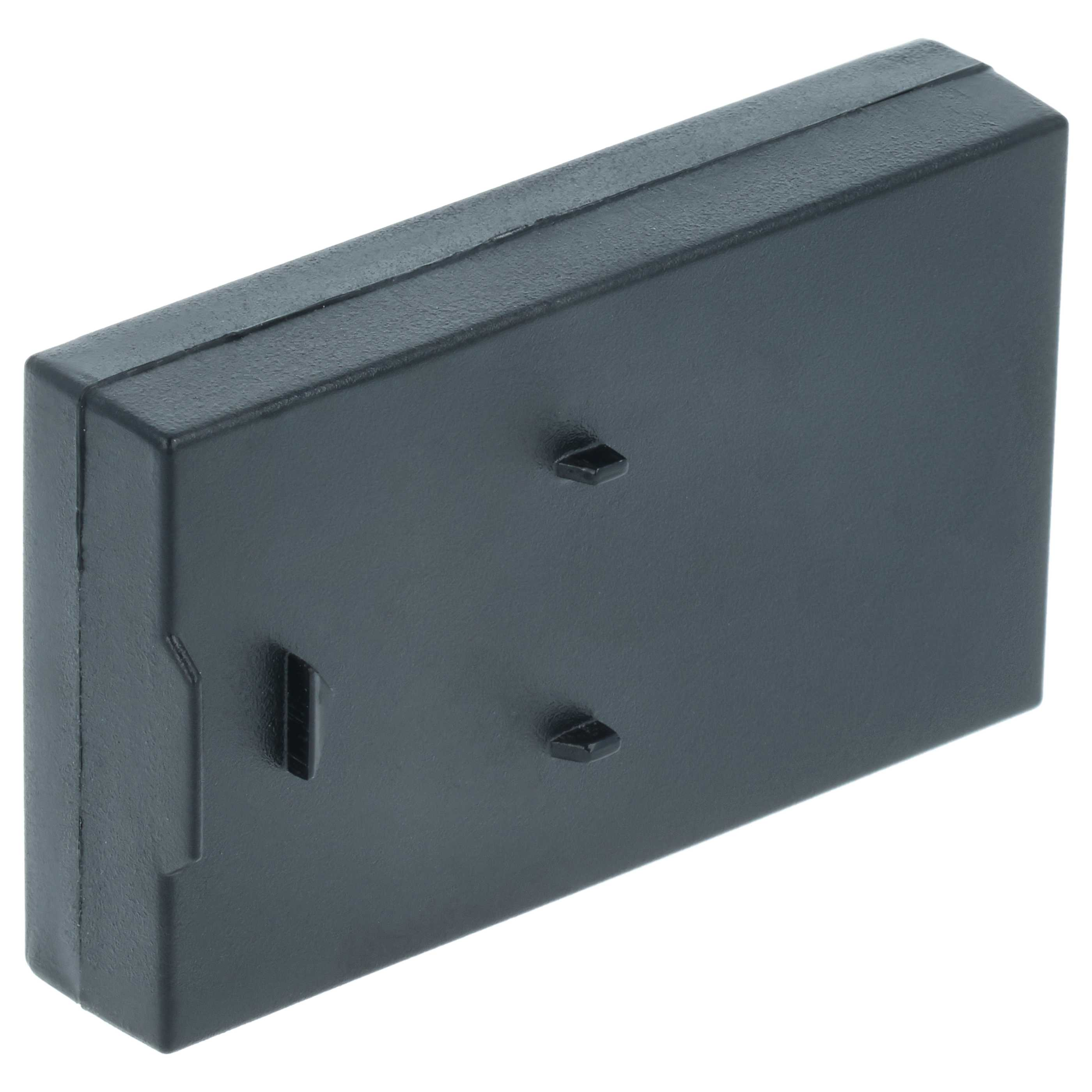 Eine schwarze rechteckige Box mit zwei kleinen Erhebungen auf der Vorderseite.