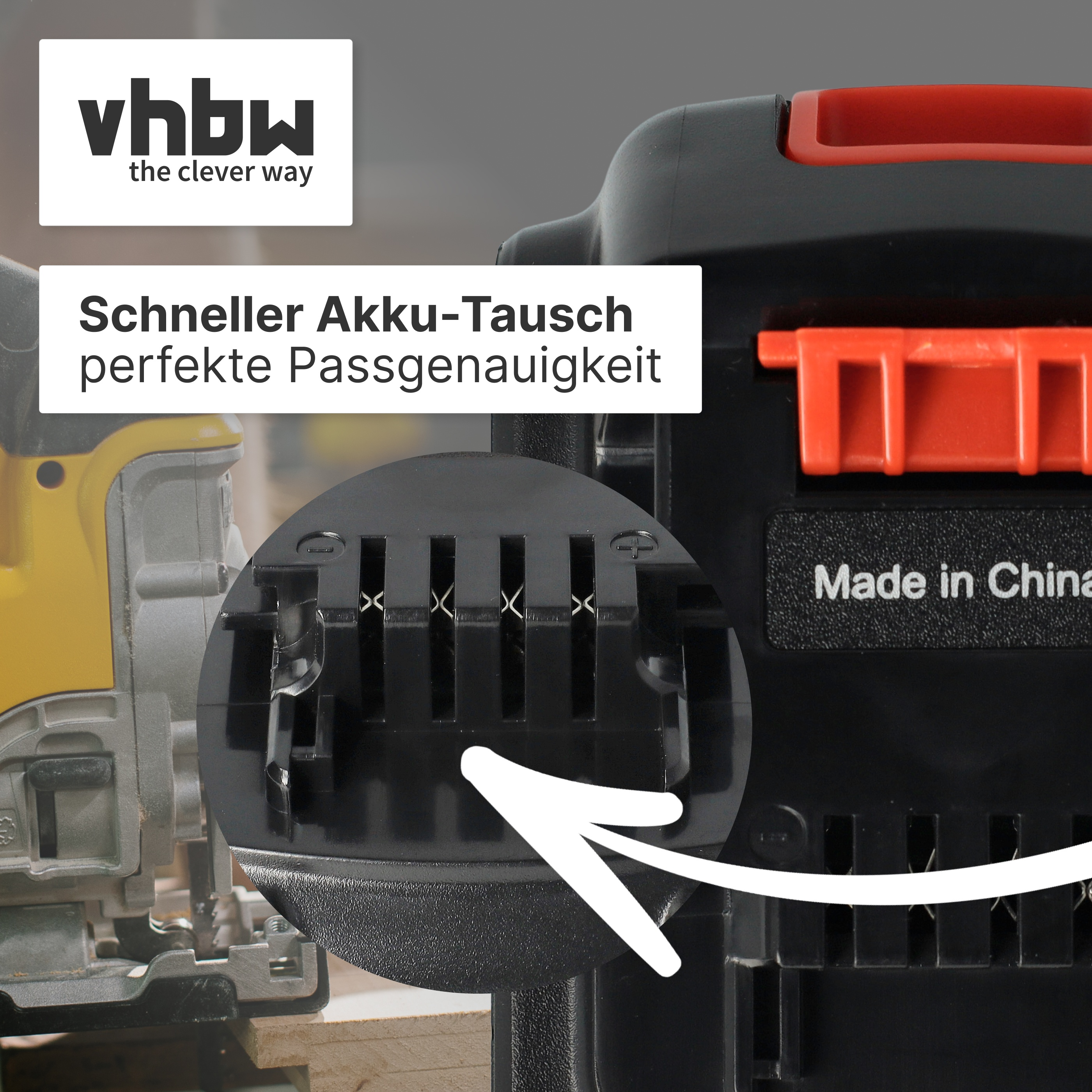 Vordergrund: Schwarzes Gehäuse mit rotem Griff. Nahaufnahme von Batterieanschlüssen.