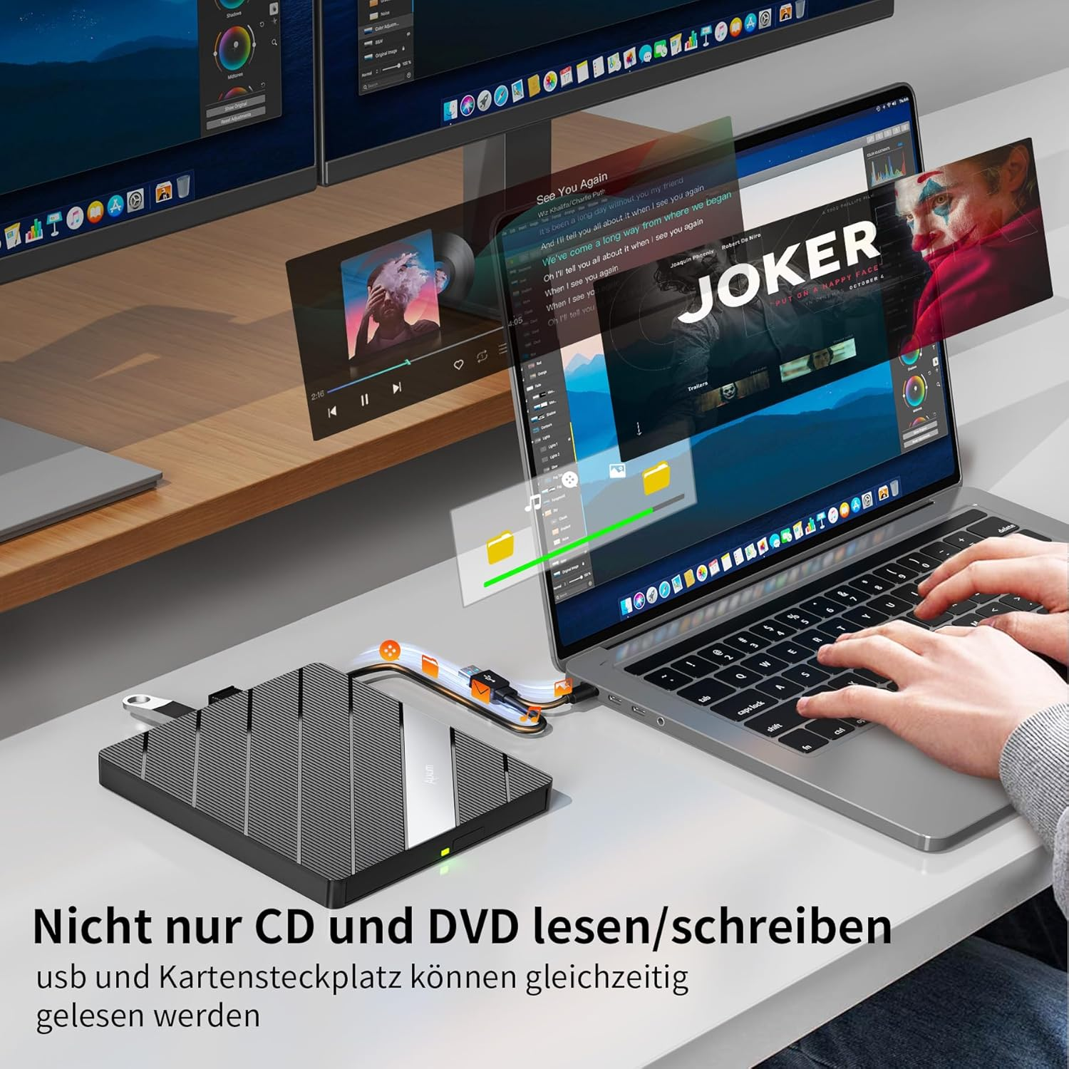 Ein Laptop, zwei Monitore und ein externes Laufwerk auf einem Schreibtisch.
