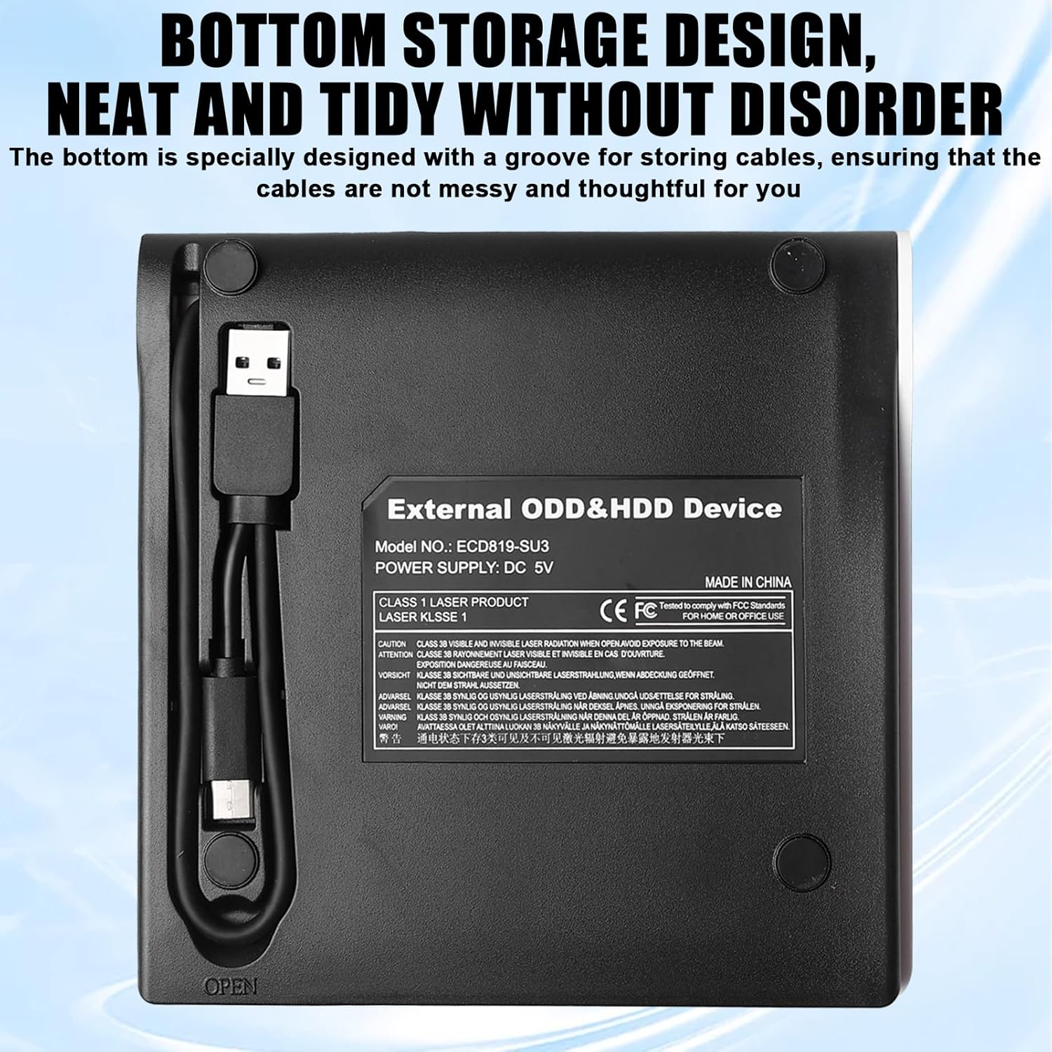 Schwarzes externes ODD&HDD-Gerät mit Kabel und CE-FC-Siegel. Beschriftung mit Warnhinweisen.