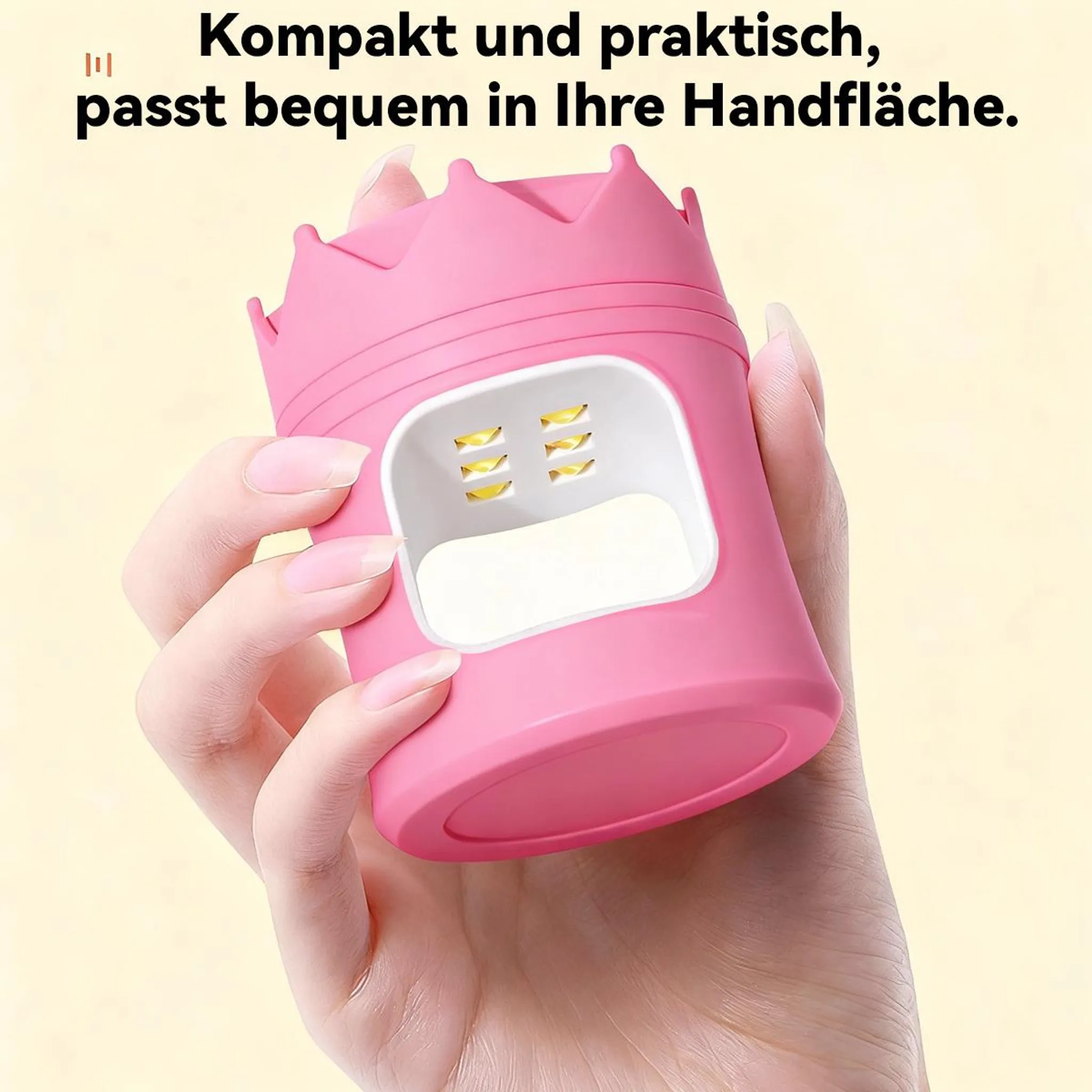 Eine Hand hält ein kleines, pinkes Nagel-UV-Licht mit Kronenform.