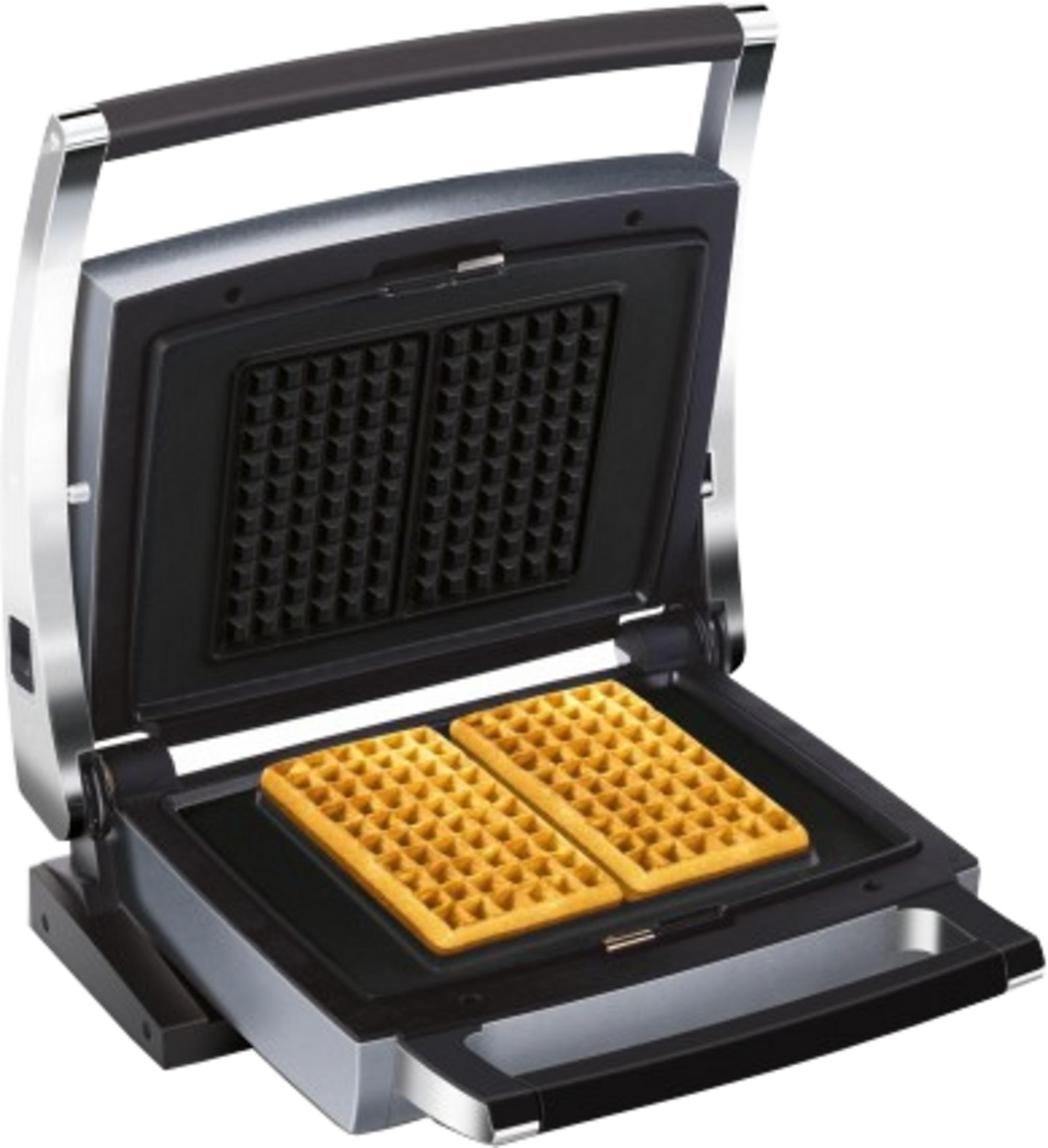 Una piastra per waffle aperta con due waffle dorati all'interno.