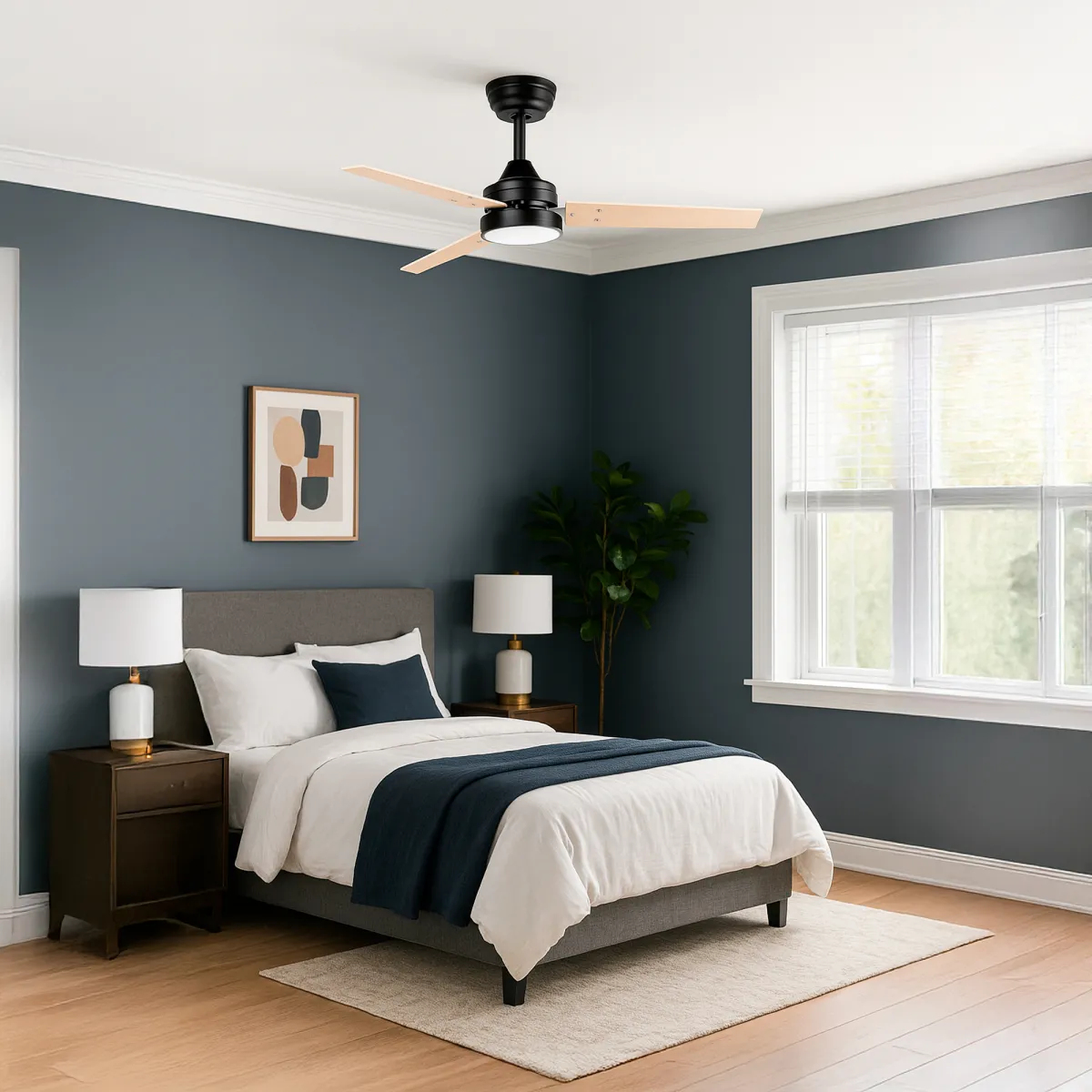 A dark bedroom featuring a bed, nightstands, a lamp, and a ceiling fan.
