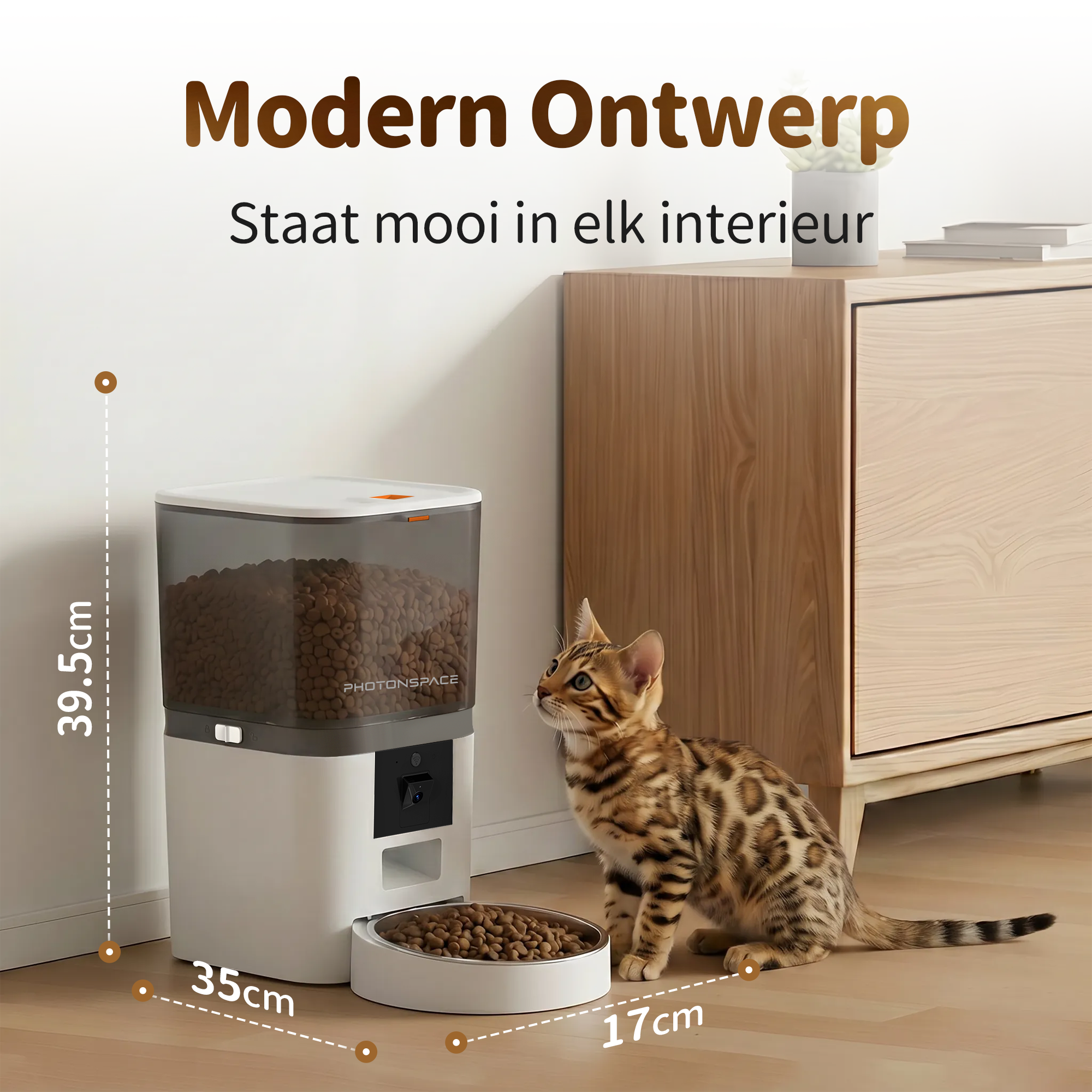 A Bengal kitten looks up at a white pet feeder with food in a bowl.