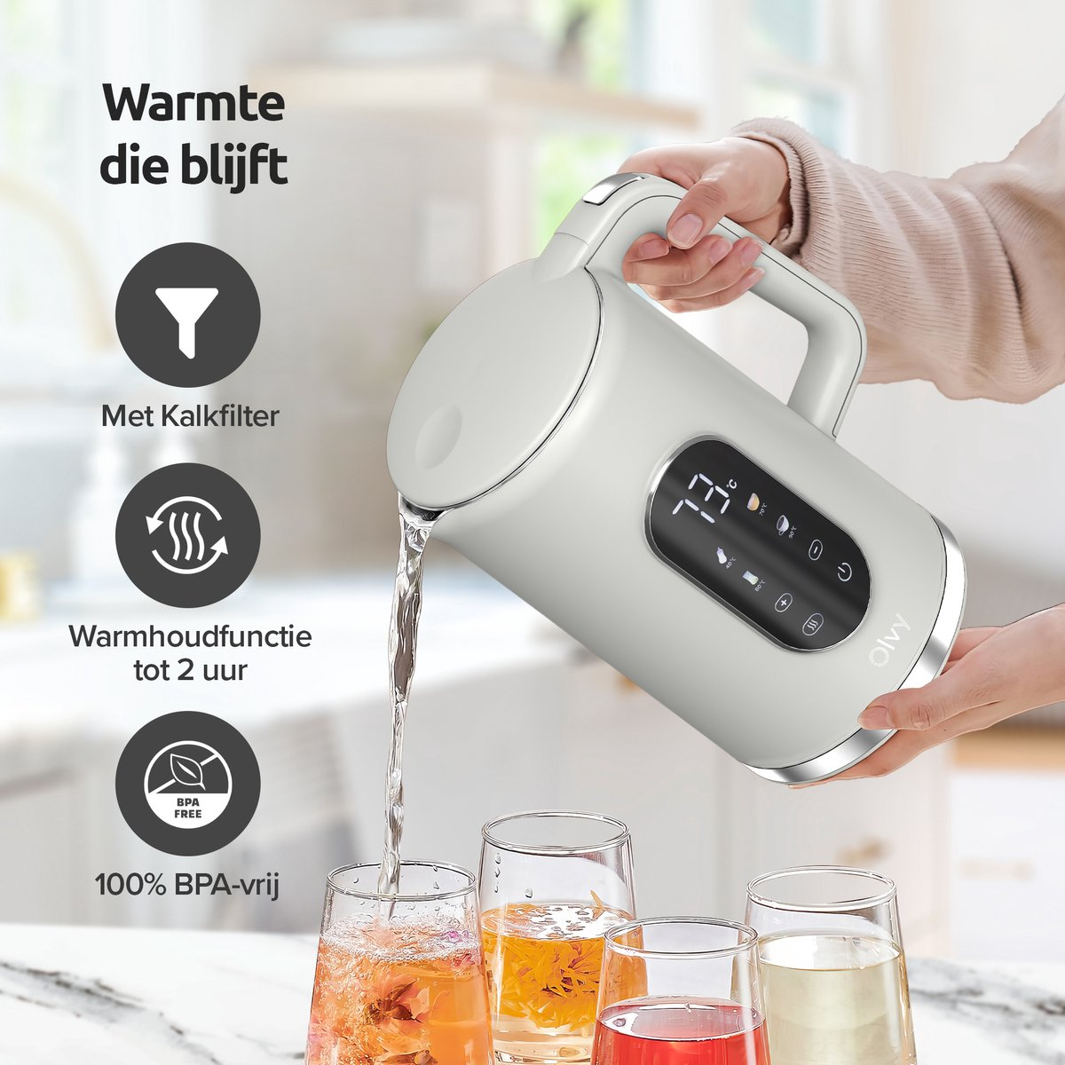 A white kettle pours water into glasses. It has a digital display.