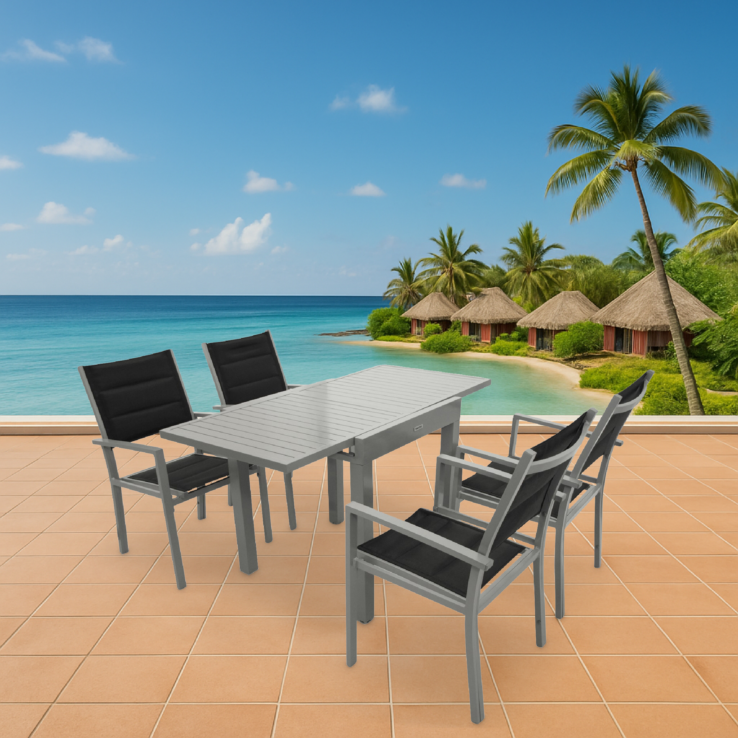 Grauer Tisch und Stühle auf einer Terrasse mit Blick auf das Meer und Hütten.
