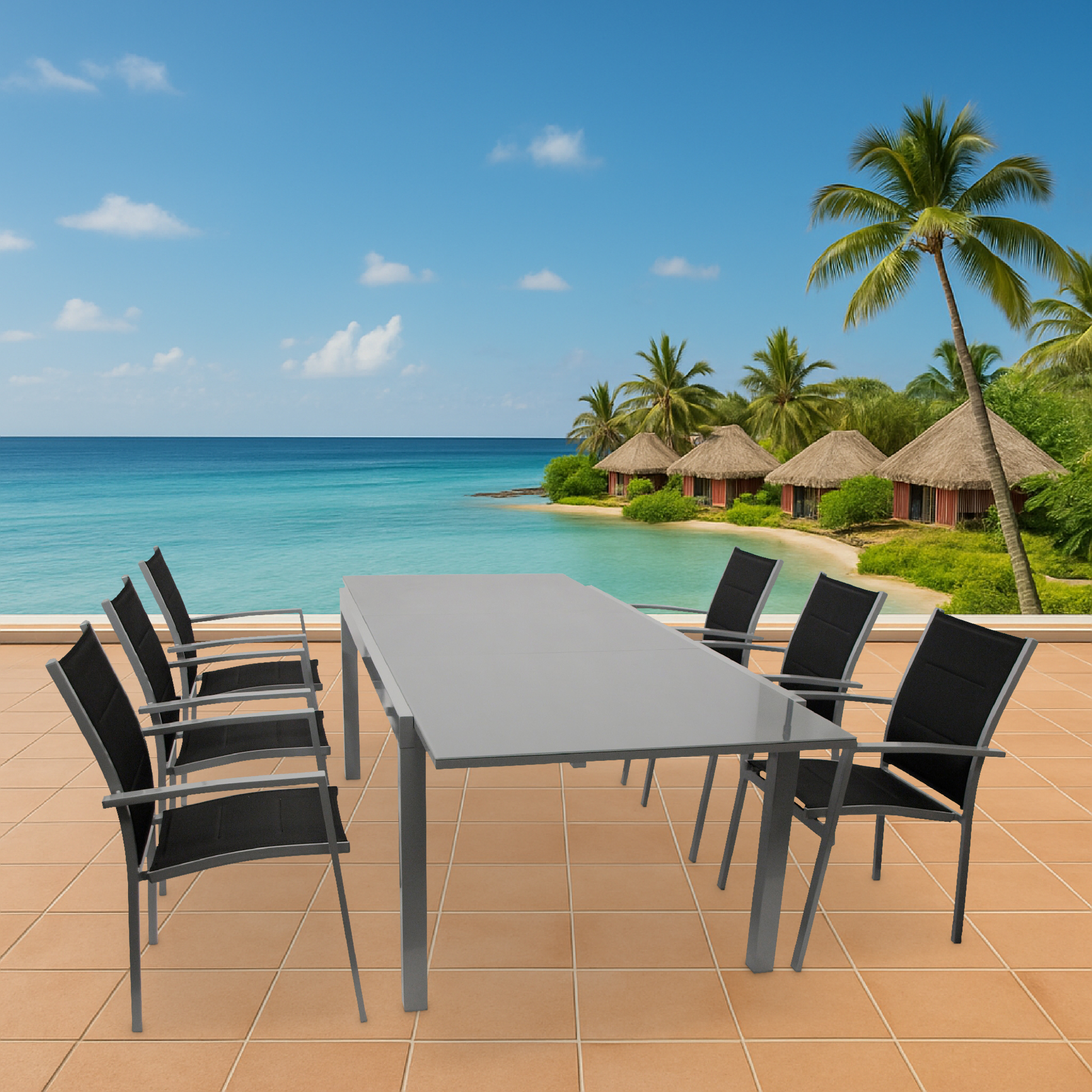 Ein Tisch und sechs Stühle auf einer Terrasse mit Blick auf das Meer und Hütten.