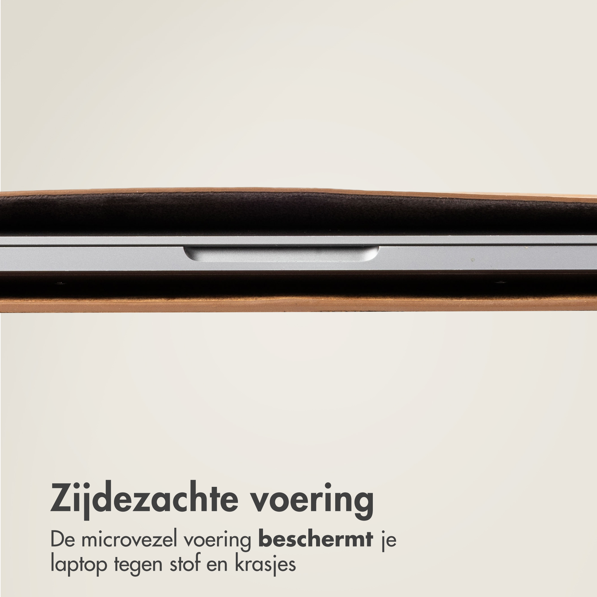 A silver laptop in a brown leather case with dark lining.