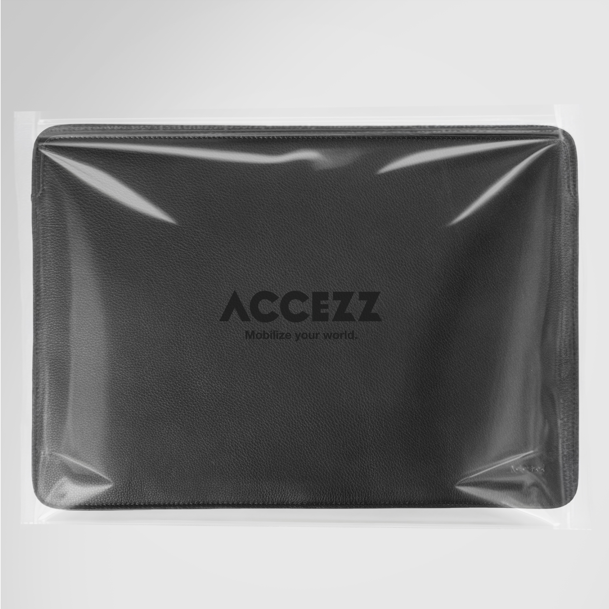 Black leather laptop sleeve in clear packaging with ACCEZZ logo.