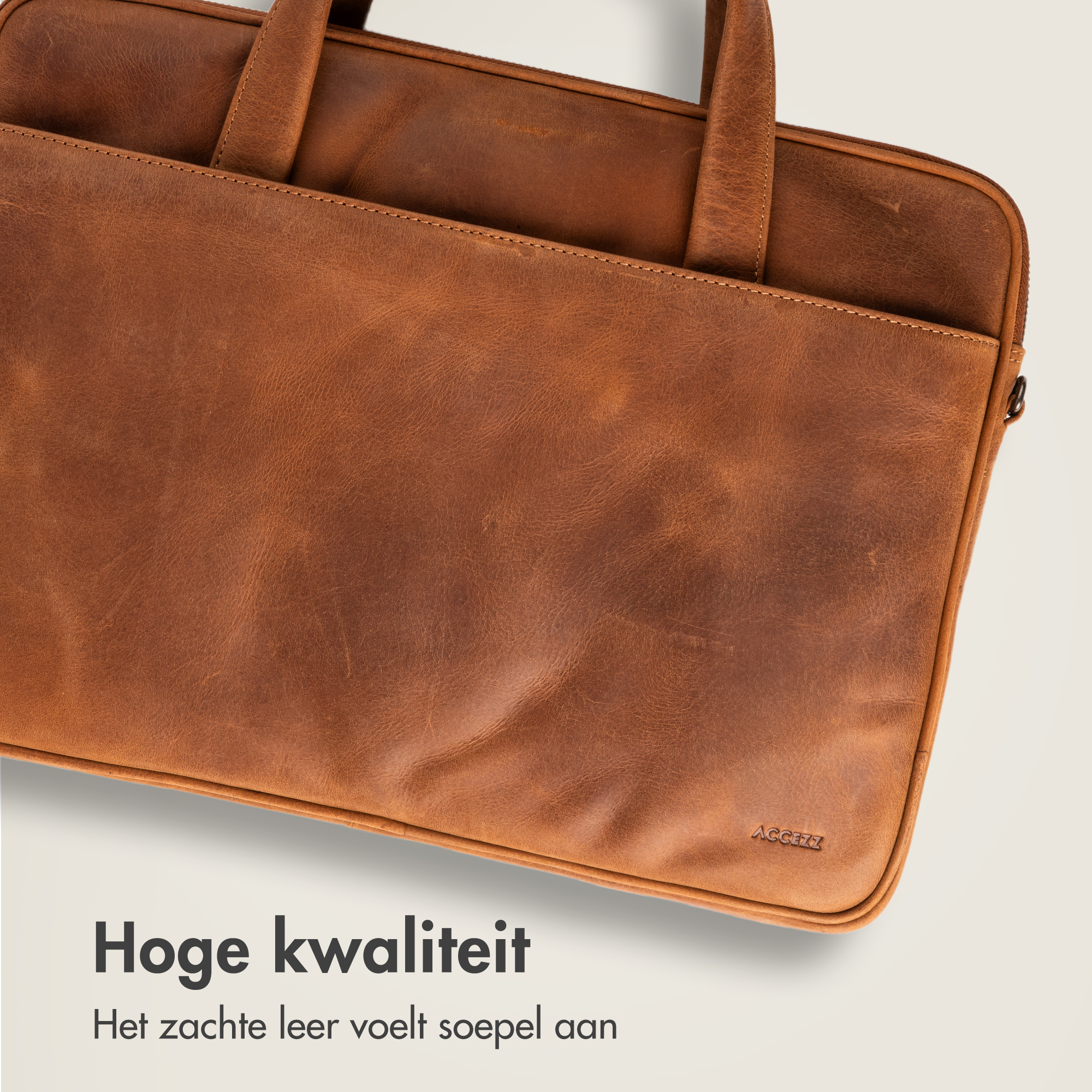 Close-up of a brown leather briefcase with handles and embossed logo.