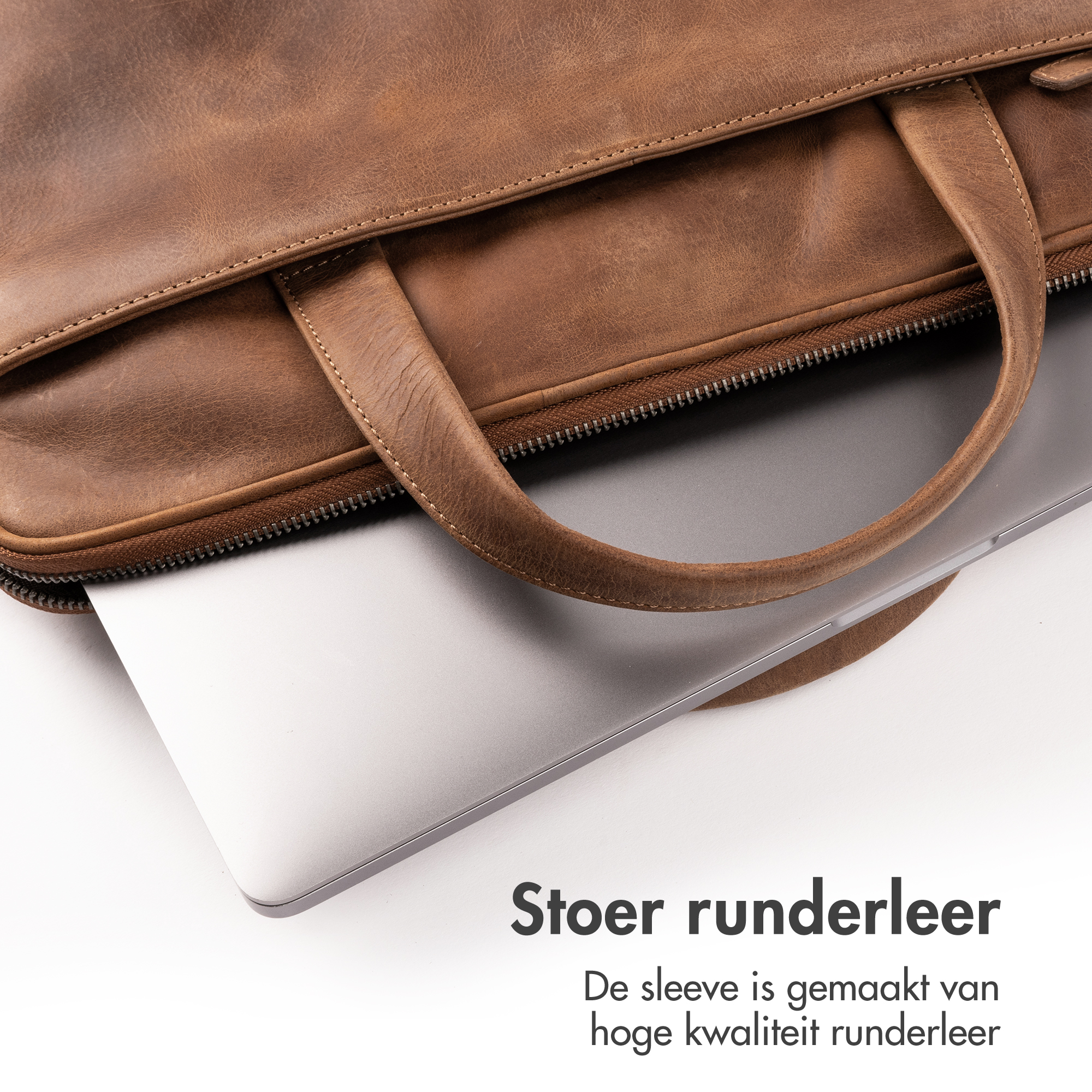 Brown leather bag with laptop beside it. High-quality leather.