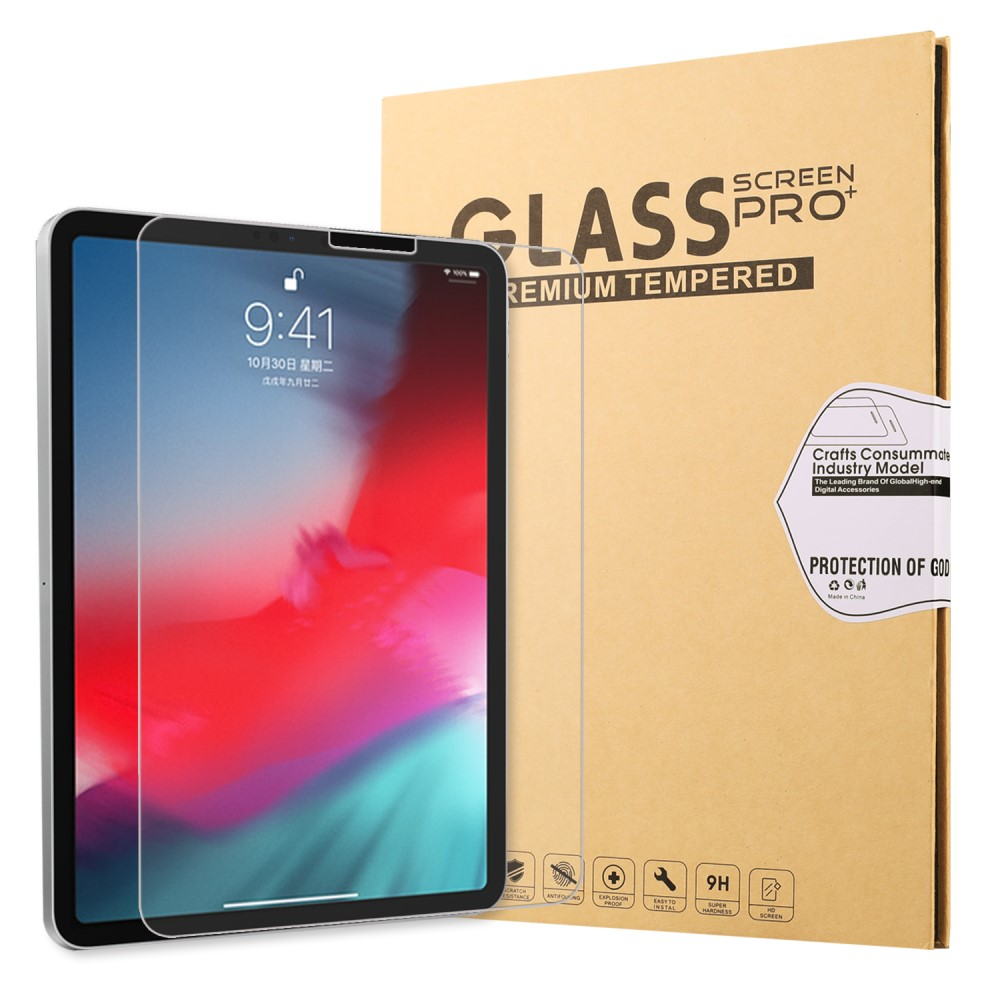 Une tablette avec un protecteur d'écran et une boîte en carton à côté.