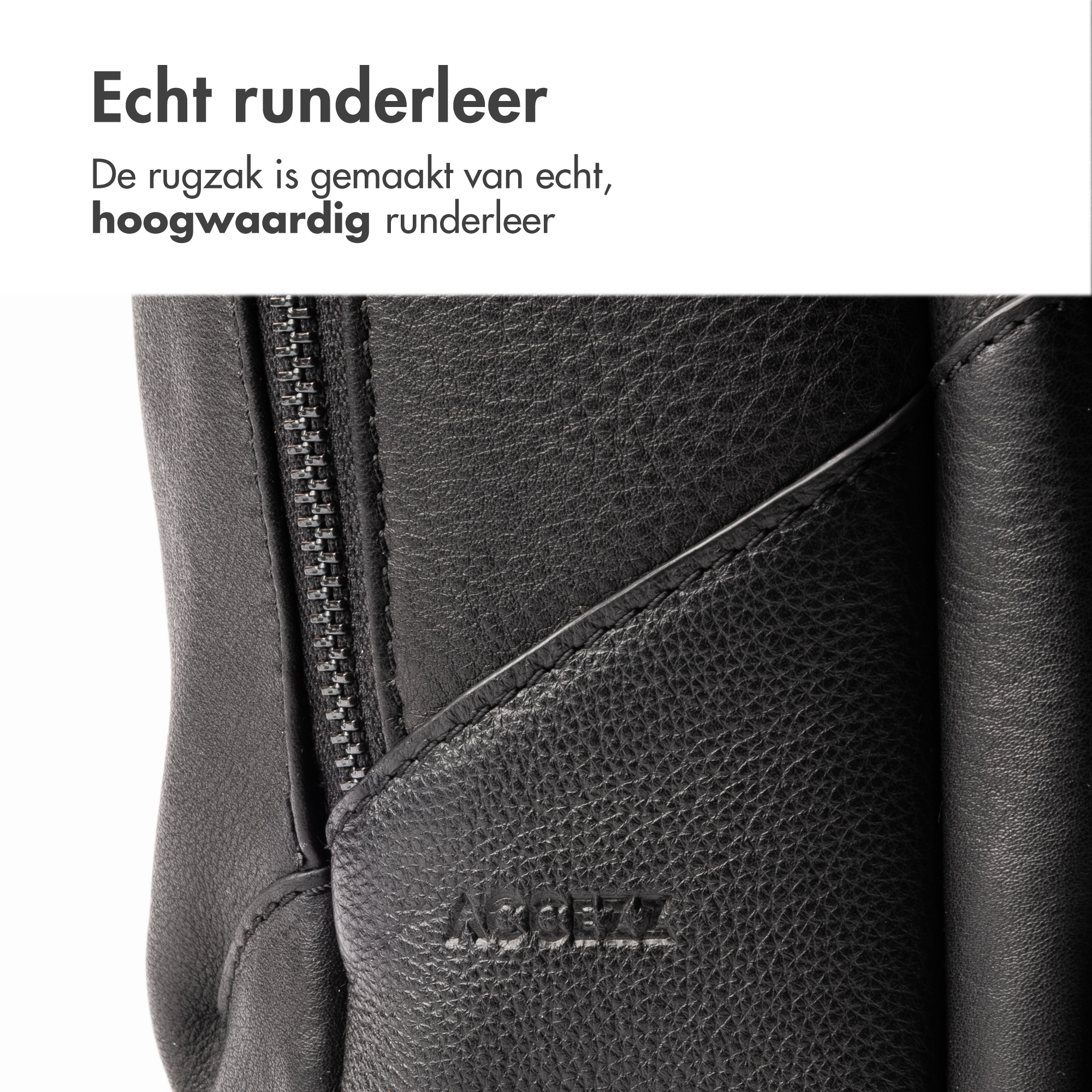 Close-up of a black leather bag with a zipper and embossed logo.