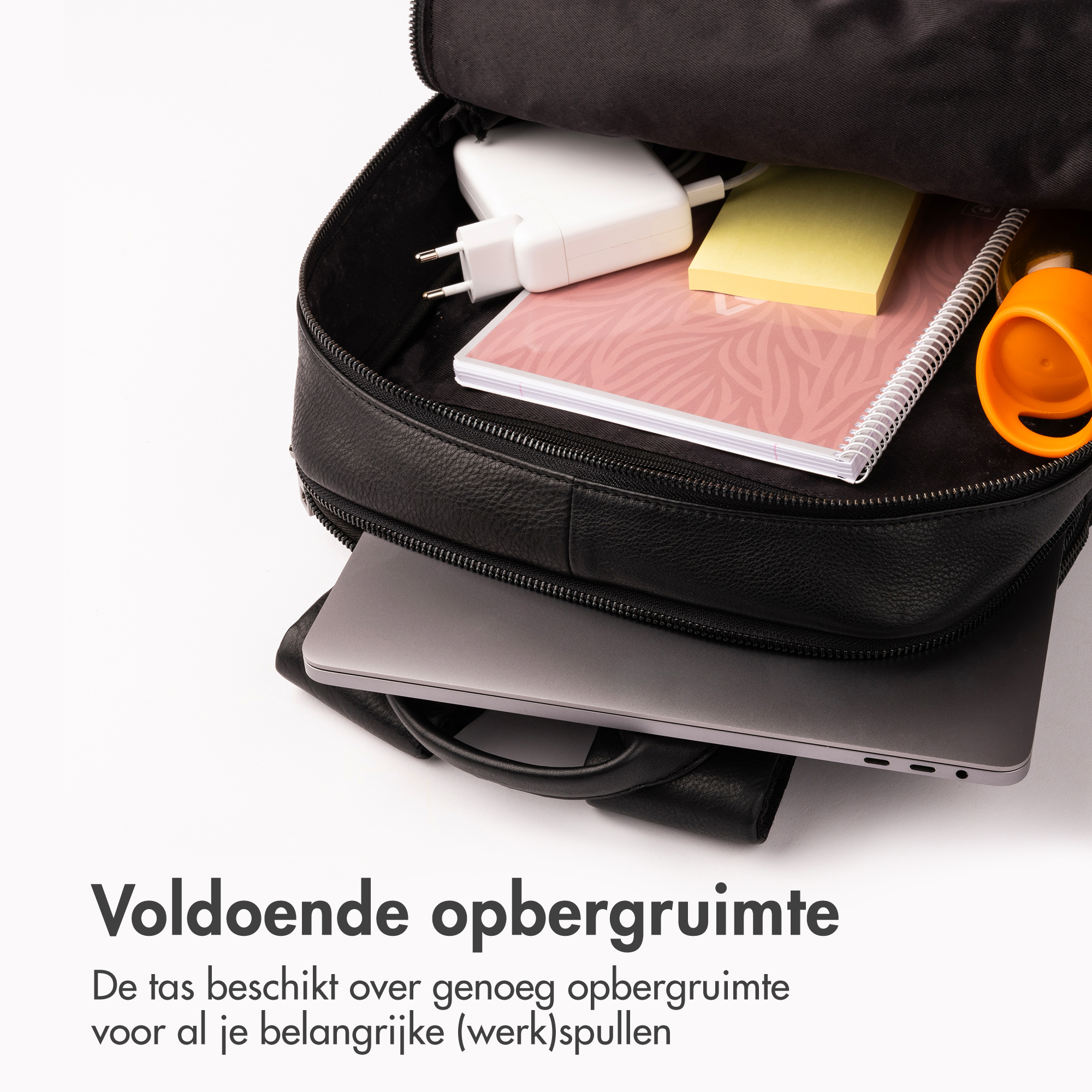Black backpack with laptop, charger, notebook, and sticky notes inside.