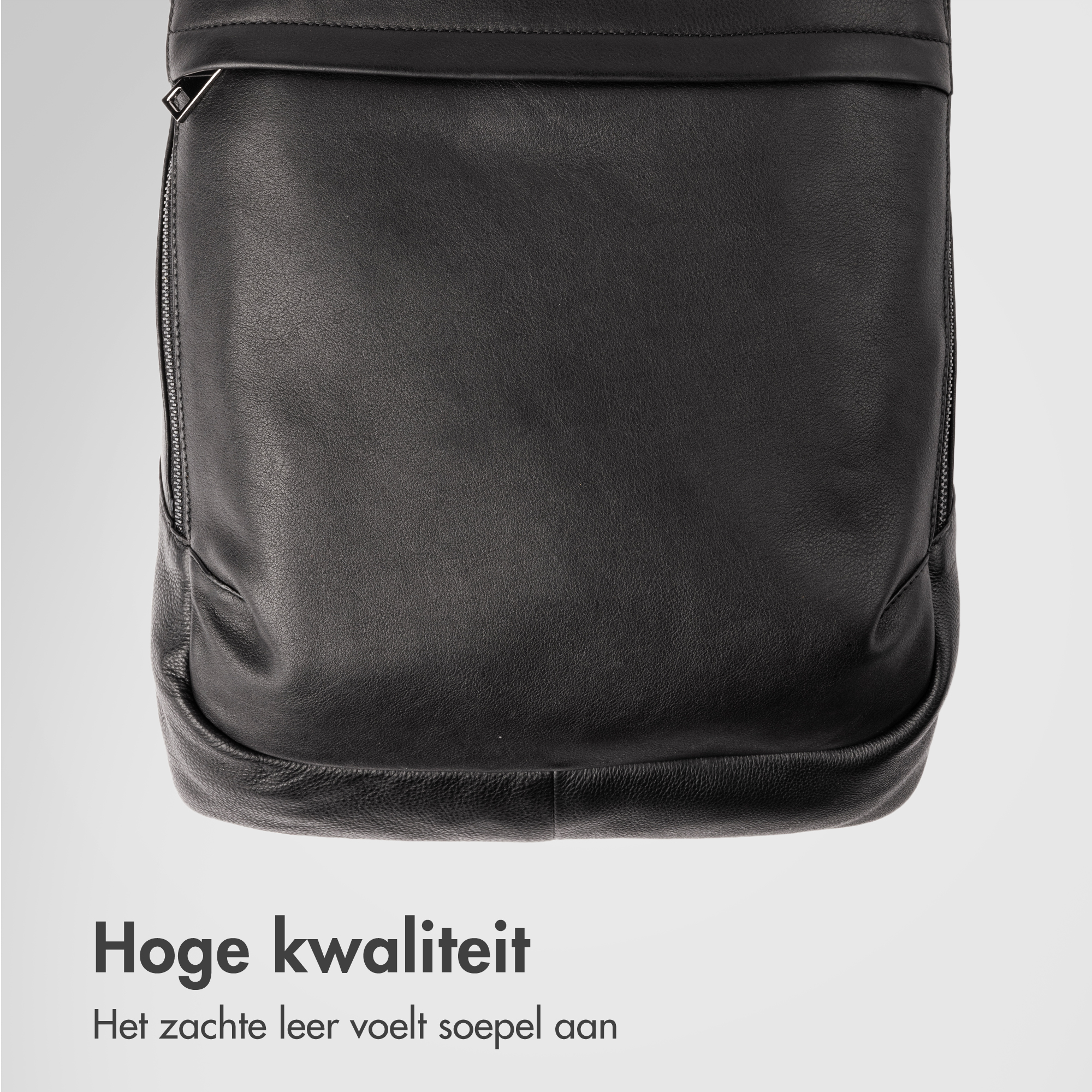 Close-up of a black leather bag showing zipper and stitching details.