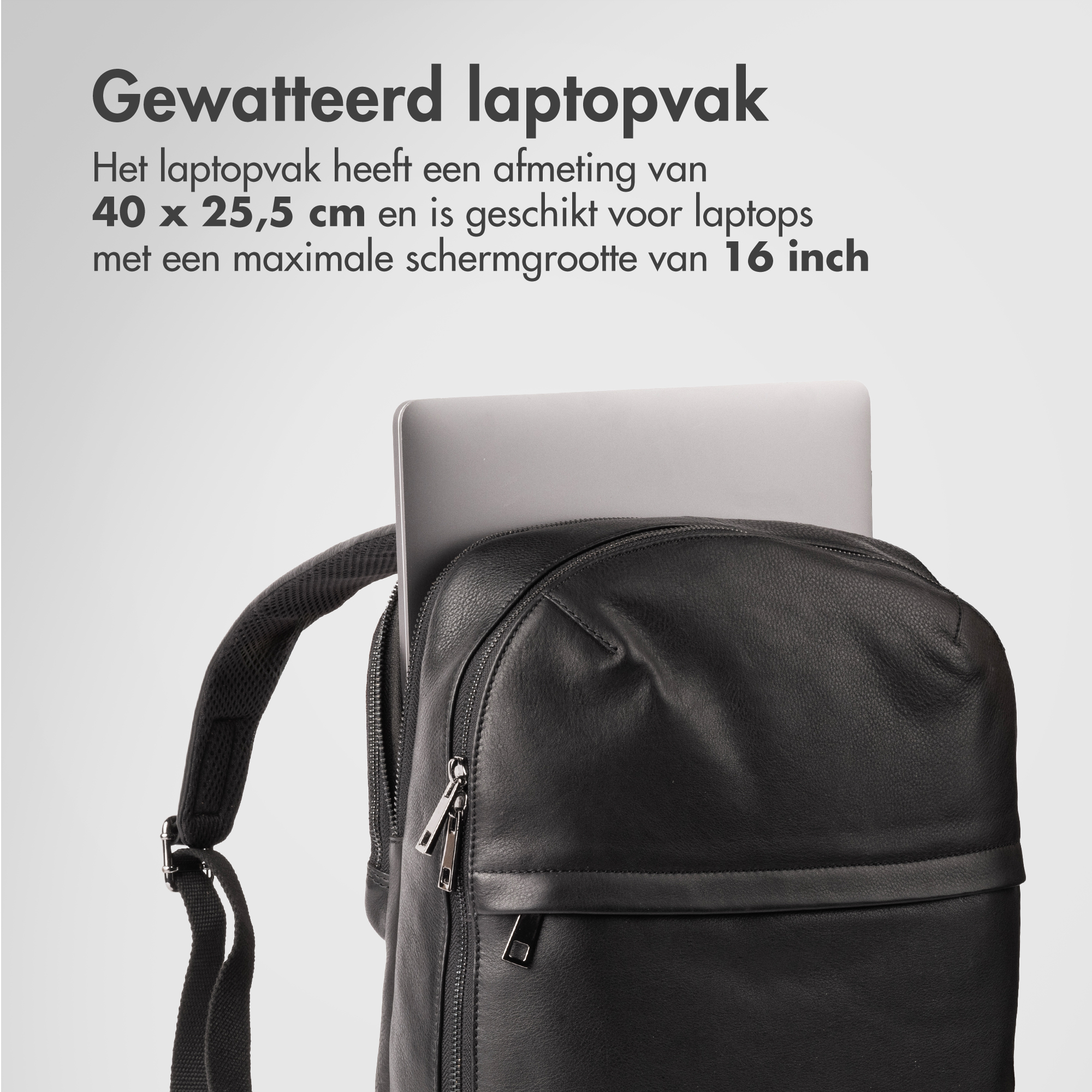 A padded laptop compartment in a black backpack with a laptop inside.