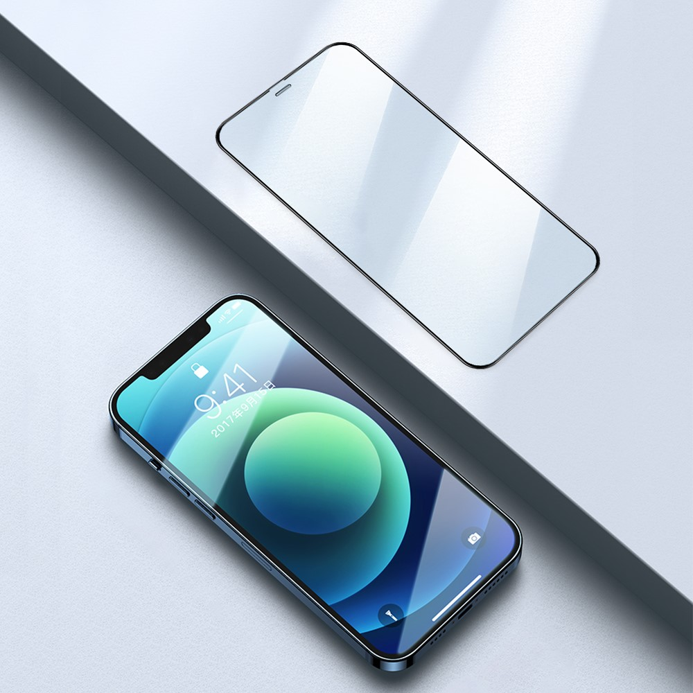 Uno smartphone giace accanto a una protezione dello schermo su una superficie grigia.
