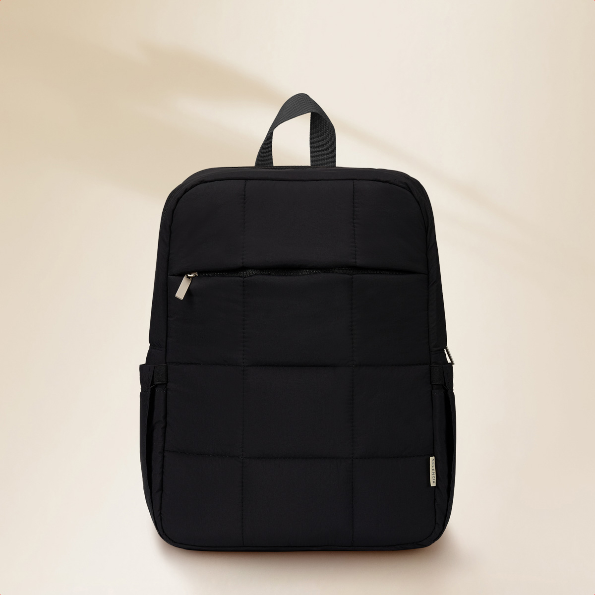 A black, quilted backpack with a zipper and side pockets.