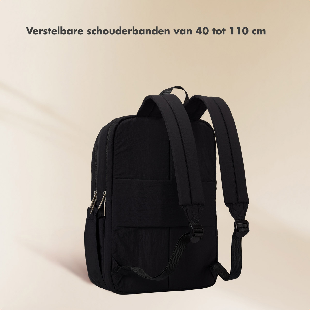 A black backpack with adjustable straps on a light background.