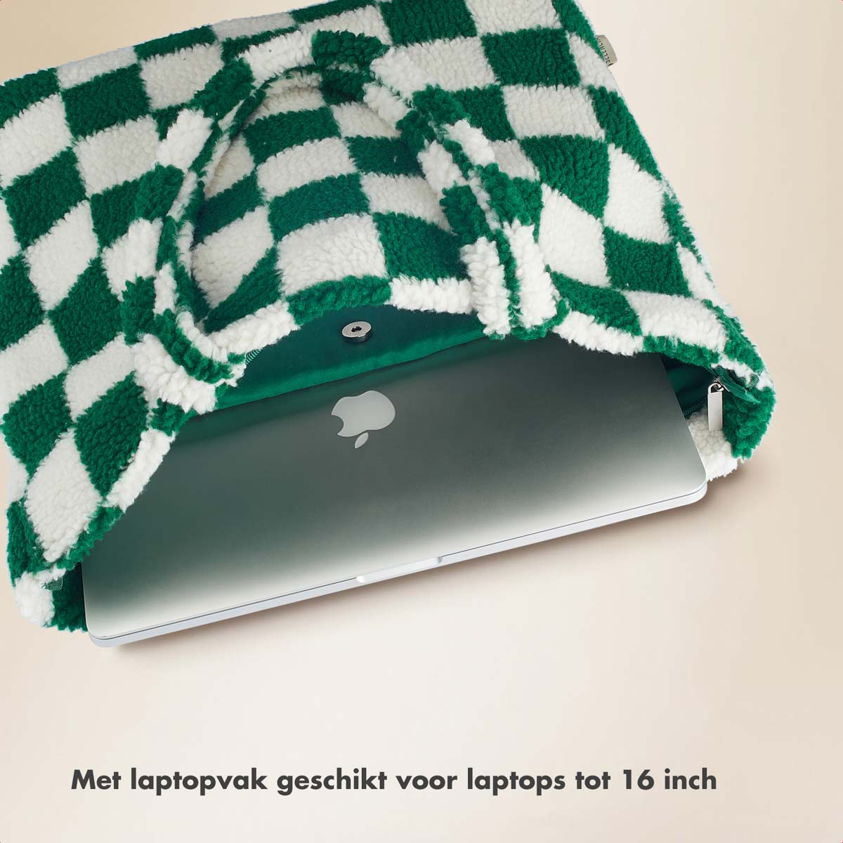 Green and white checkered sherpa tote bag with laptop and zipper.