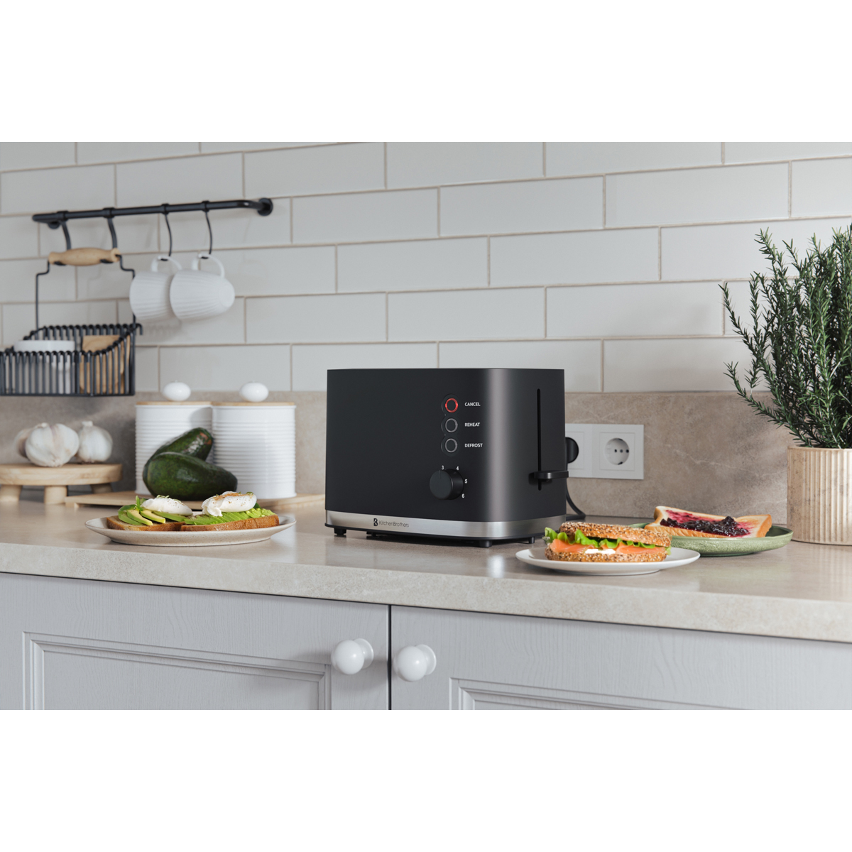 A black toaster sits on a kitchen counter next to avocado toast and a sandwich.