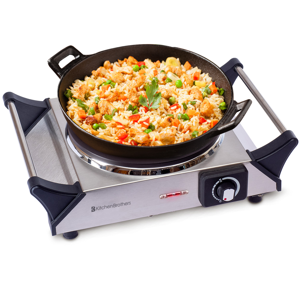A cast iron pan filled with fried rice, chicken, and vegetables sits on an electric hot plate.