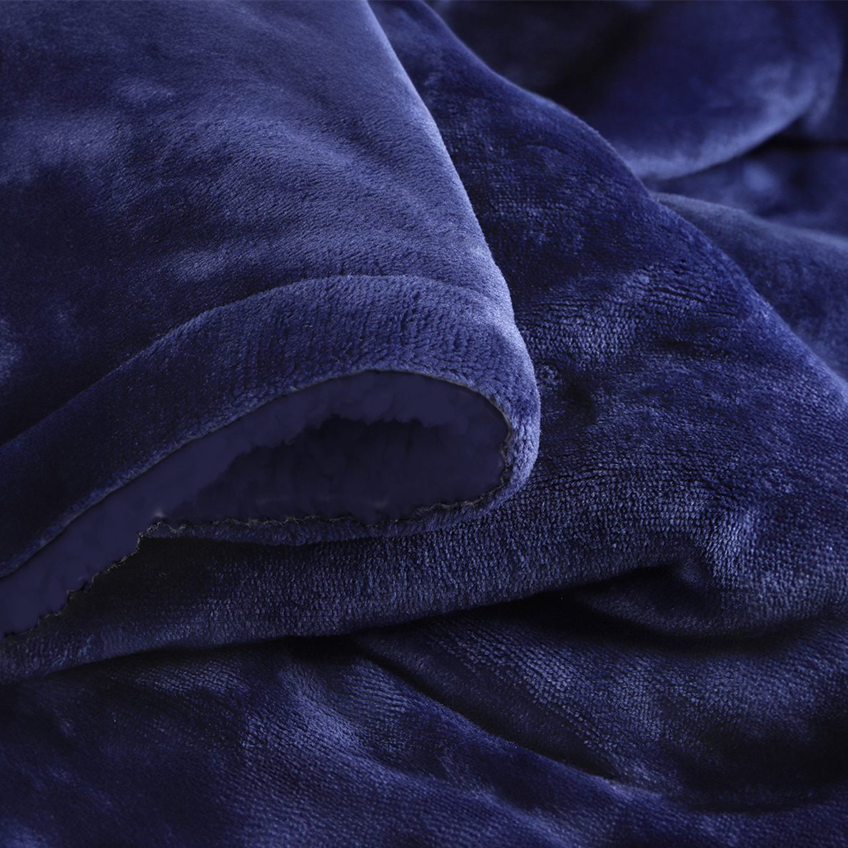 Couverture bleue marine en tissu doux repliée sur elle-même.