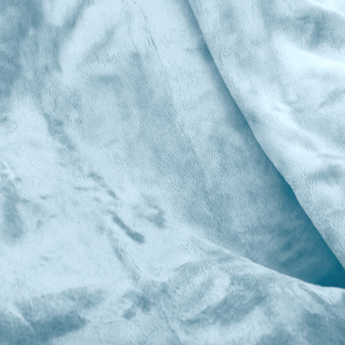 A light blue, fuzzy blanket with folds.